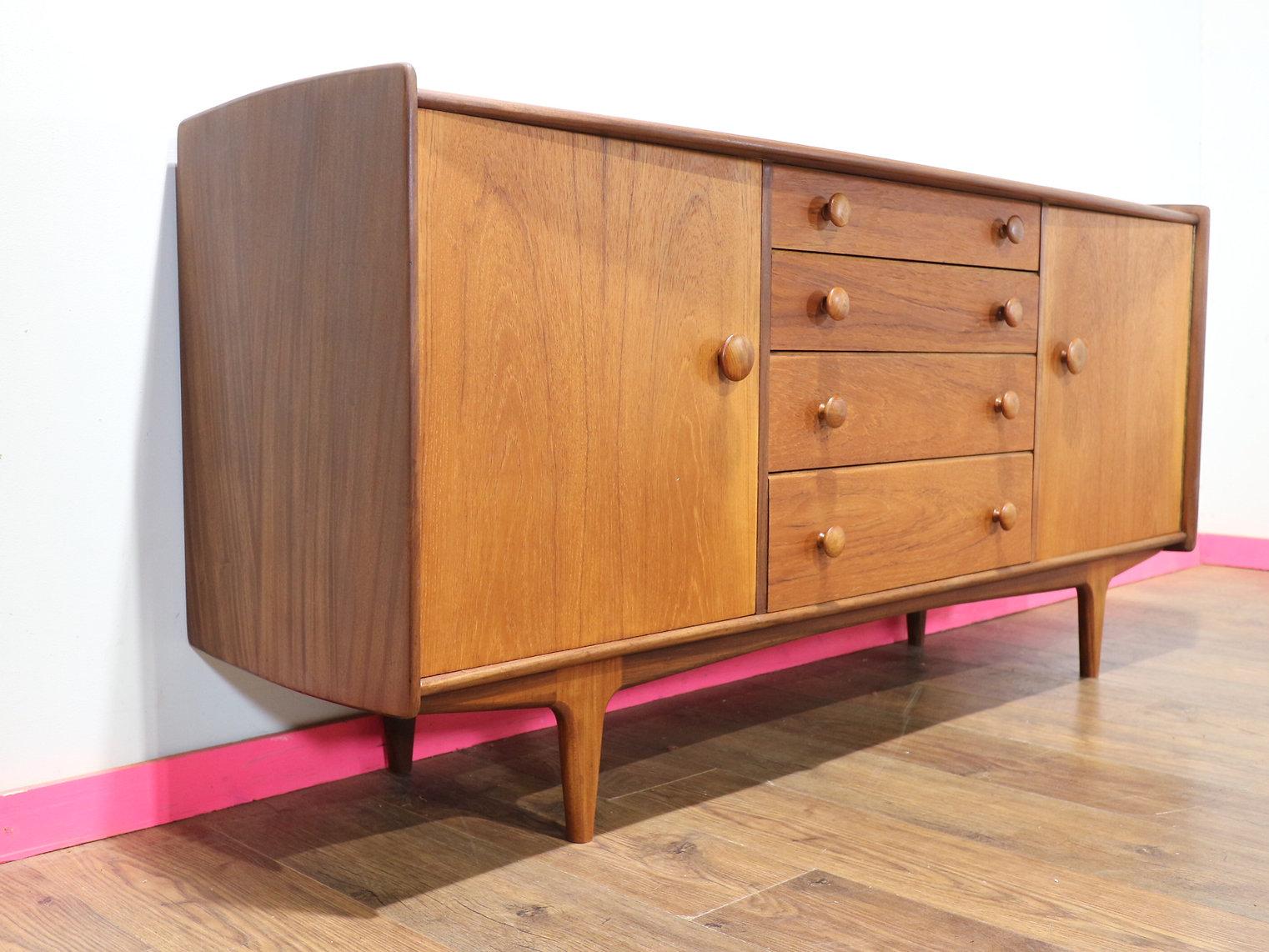 At Mid Century Traders, we are proud to present this stunning credenza by British furniture maker Younger. Made from the finest Afromosia, this piece exemplifies fantastic craftsmanship and timeless Danish style. Perfect for enthusiasts of