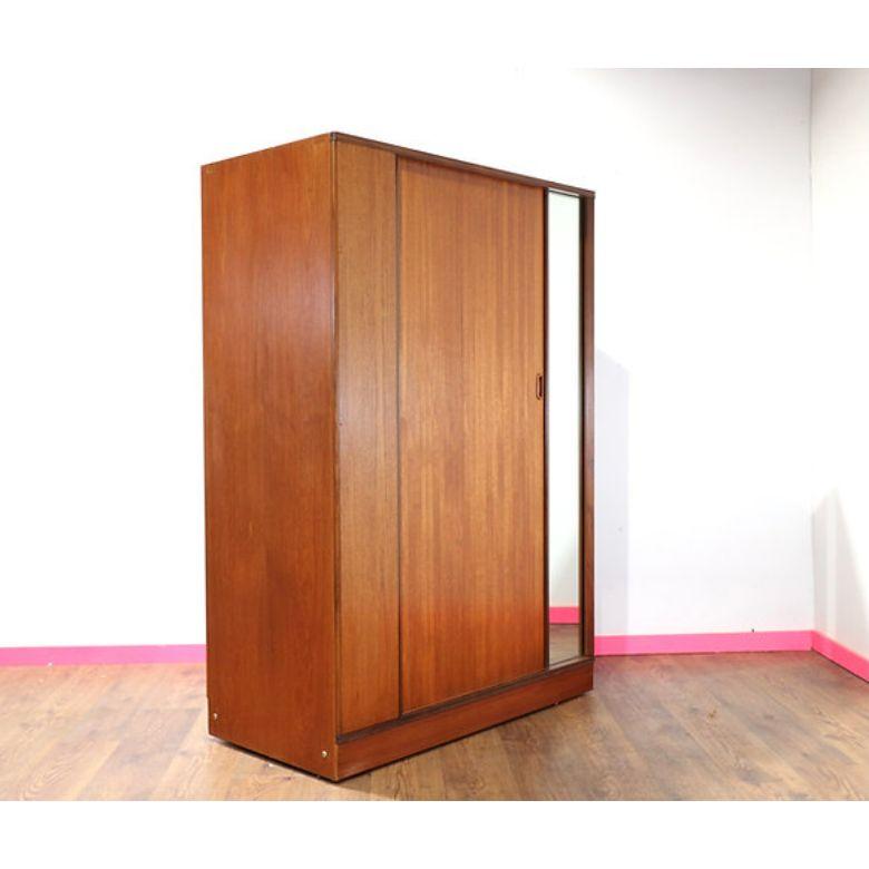A gorgeous Mid Century armoire by renowned British furniture maker, Austinsuite.  The main feature (apart from the great storage) is the tambour door which sets this armoire apart from the rest.

Dims
w48 d68.5 h23

Condition
This armoire is in