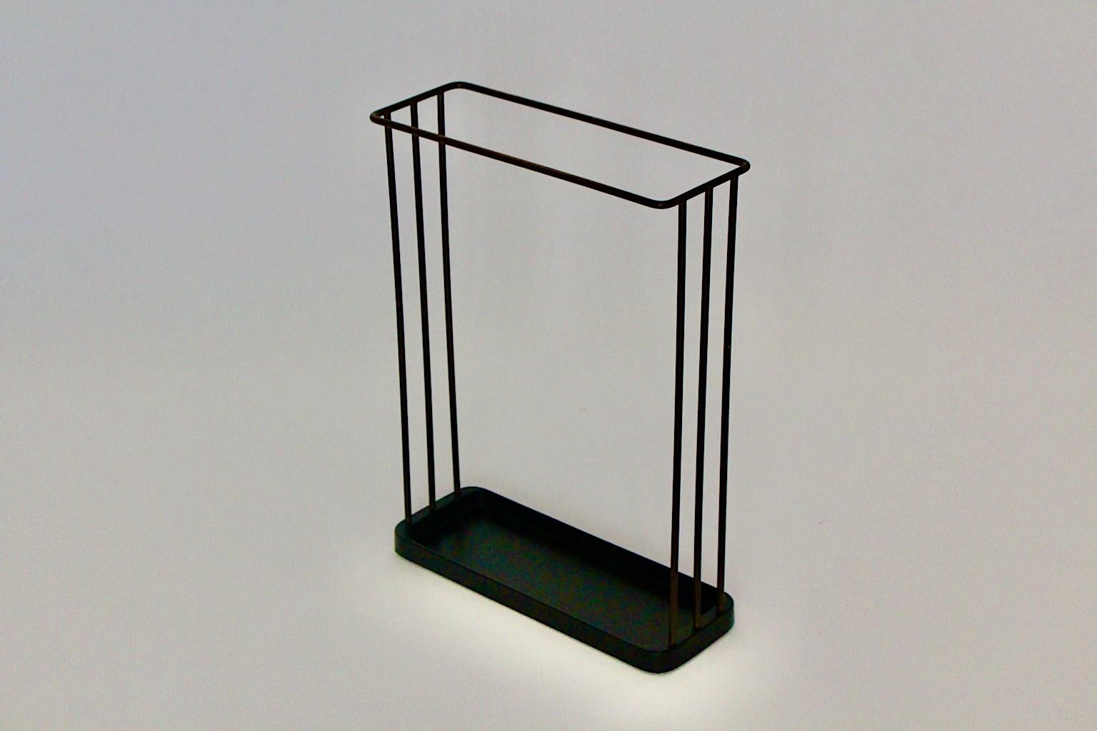 A Mid-Century Modern vintage black brass umbrella stand by Franz Hagenauer  for Workshop Hagenauer, 1950s, Austria.
Franz Hagenauer (  1906 - 1986 )
A gorgeous umbrella stand from black lacquered cast iron with a solid brass construction.
This