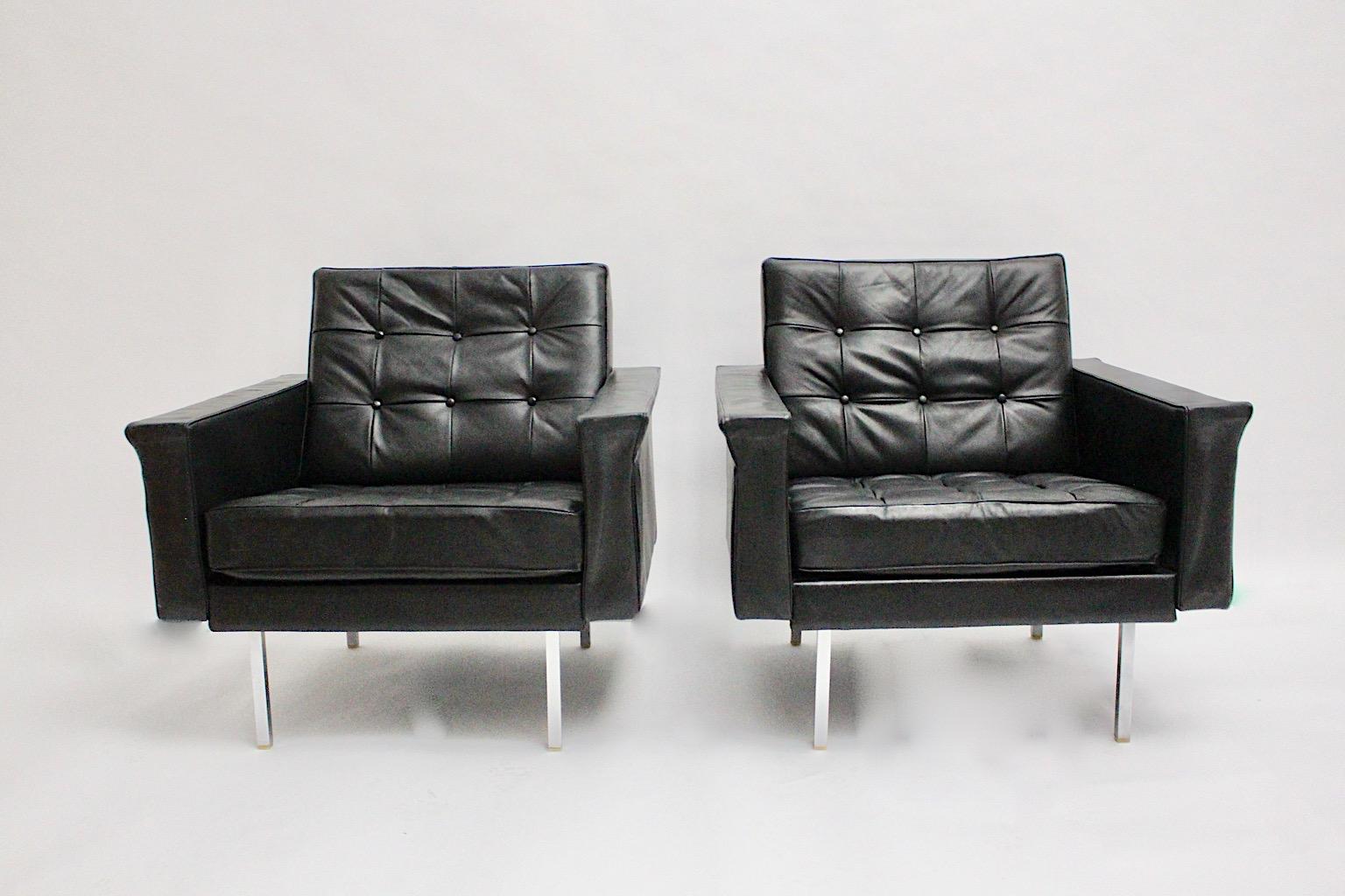 Mid-Century Modern pair of vintage freestanding lounge chairs or club chairs cubus like from stitched leather in black color by Johannes Spalt, 1960s Vienna. 
A pair of fabulous club chairs from black leather with chromed metal legs in rectangular