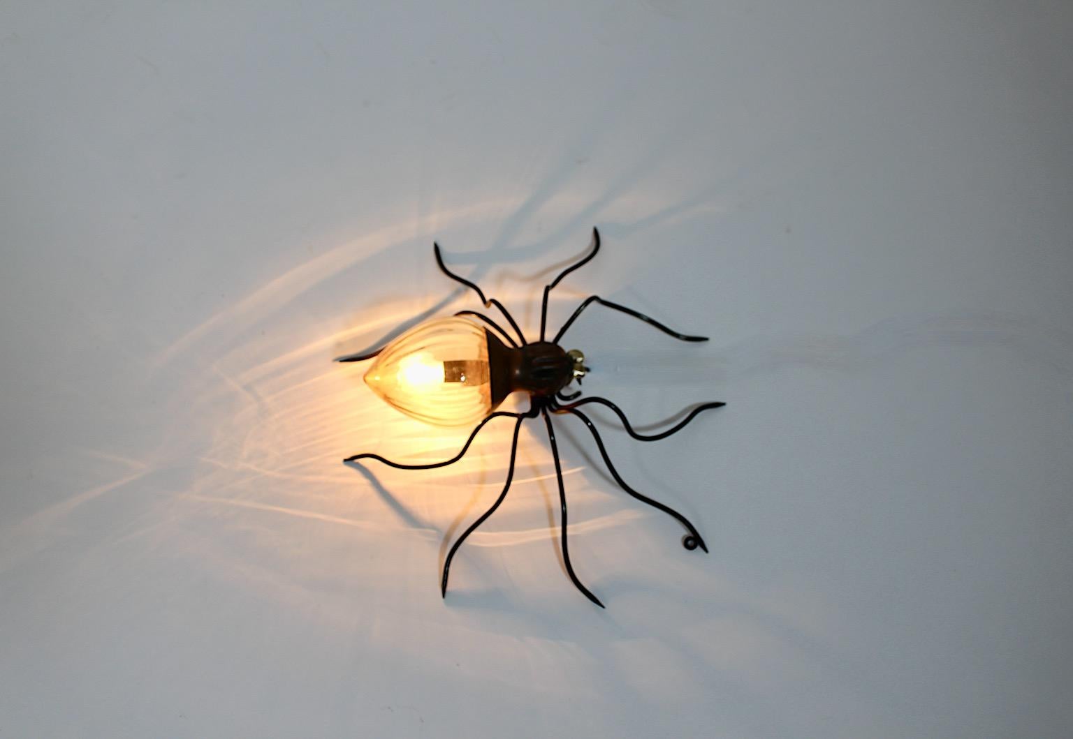 Mid Century Modern vintage spider like sconce or wall light from black metal, brass copper and yellow structured glass, 1950s Italy.
An amazing sconce or wall light with whimsical flair from yellow structured glass, black metal, brass and copper.