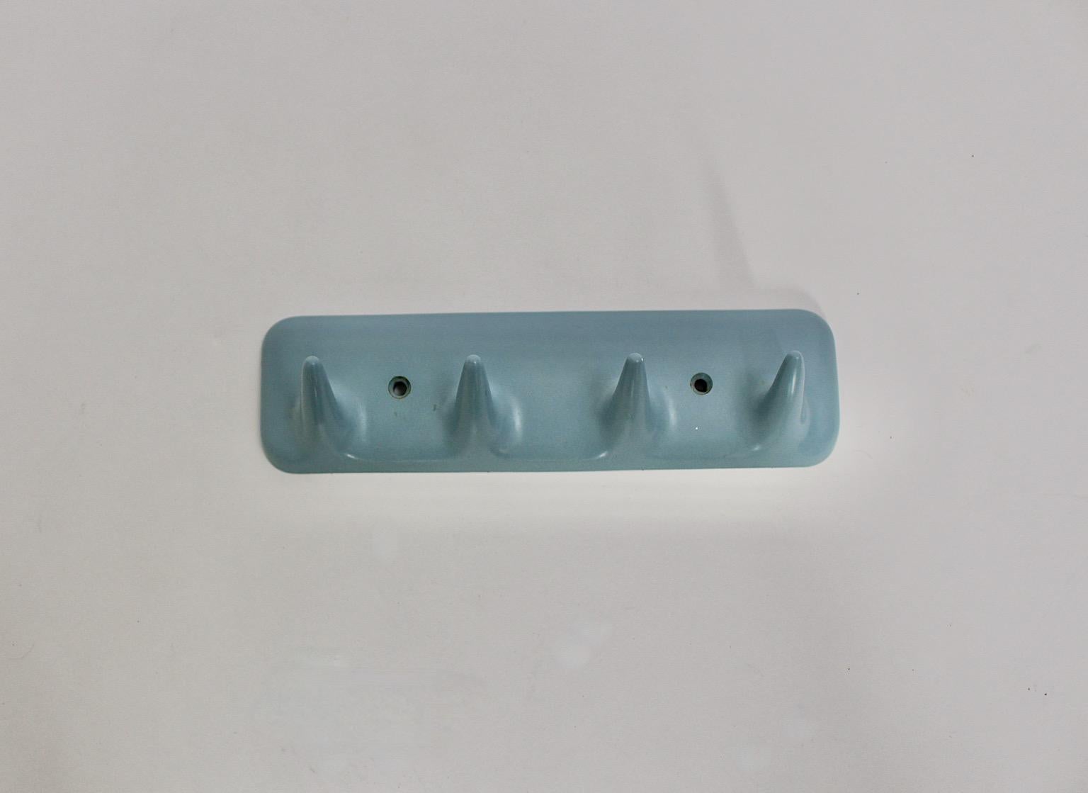 Mid-Century Modern vintage coat rack or wall hook from plastic in sky blue pastel color tone designed and manufactured 1950s Italy.
The rail shows 4 slightly curved hooks with approx. 3 cm length, which is easy to fix at the wall.
Stamped CM Mod.