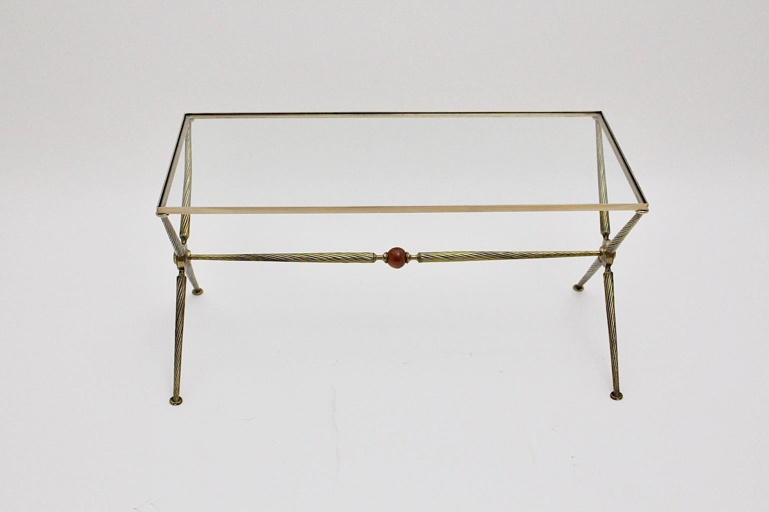 Mid Century Modern vintage sofa table or coffee table attributed to Maison Bagues, 1950s France.
An elegant and sophisticated coffee table or sofa table attributed to Maison Bagues consists of a X-base and solid turned brass conical table legs.
The