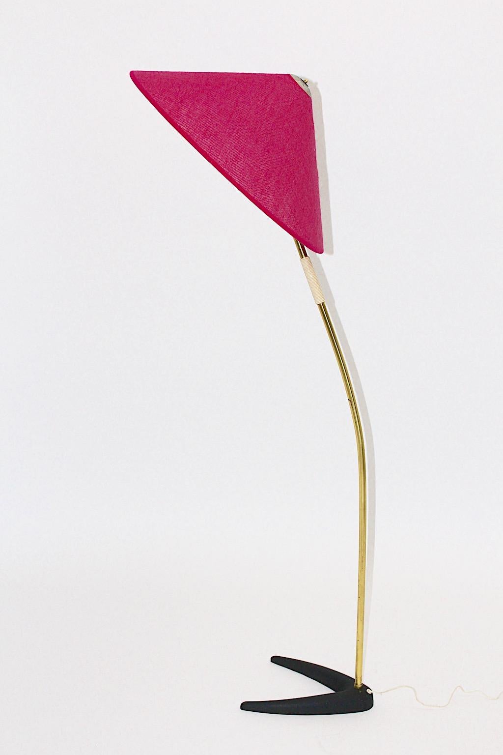 Mid Century Modern vintage brass floor lamp with black foot from iron
by J.T. Kalmar - designed and executed 1950s Vienna, Austria.
A beautiful floor lamp showing a brass curved stem with a white plastic string handle and a black lacquered cast iron
