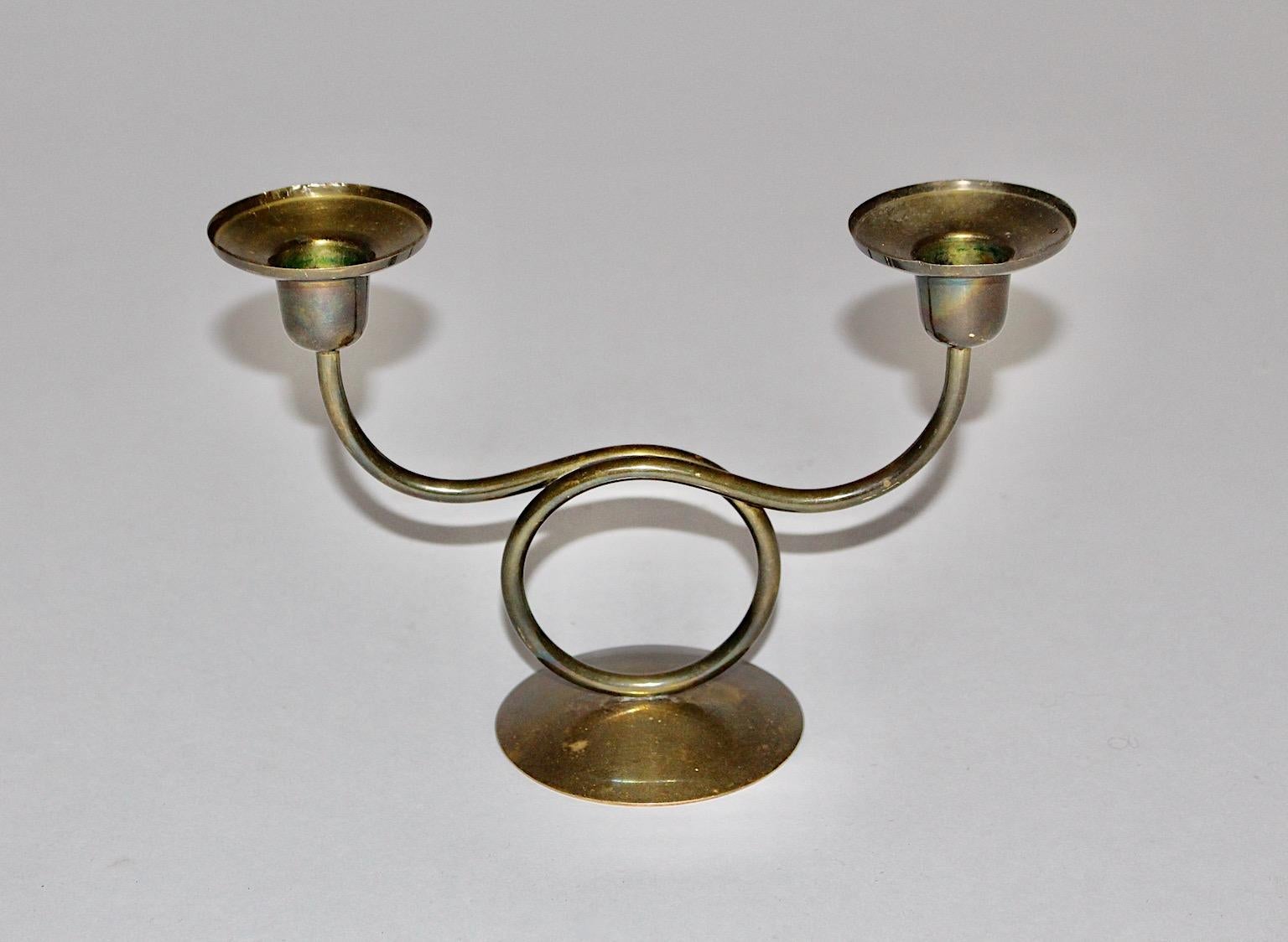 Mid Century Modern vintage candlesticks or candleholder attributed to Josef Frank for Svenskt Tenn 1950s Sweden from brass.
An amazing candlestick from brass with curved circular like decor with two tulles for candles.
Good original condition with