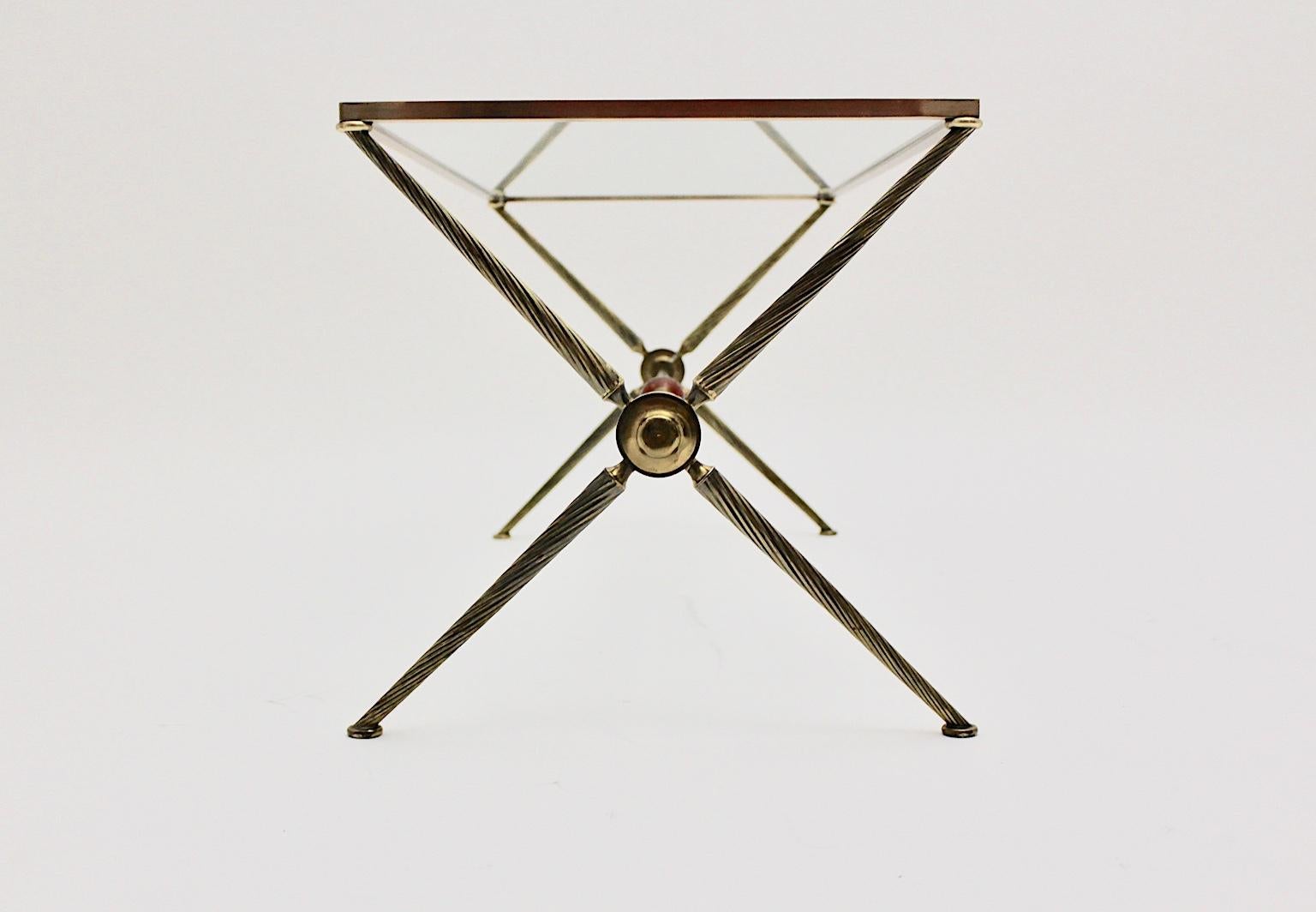 This elegant coffee table / sofa table by Maison Bagues attributed. Consists of a X-base and solid turned brass conical table legs.
The connection between the table legs is embellished with an amber colored bakelite ball.
Over the x form legs