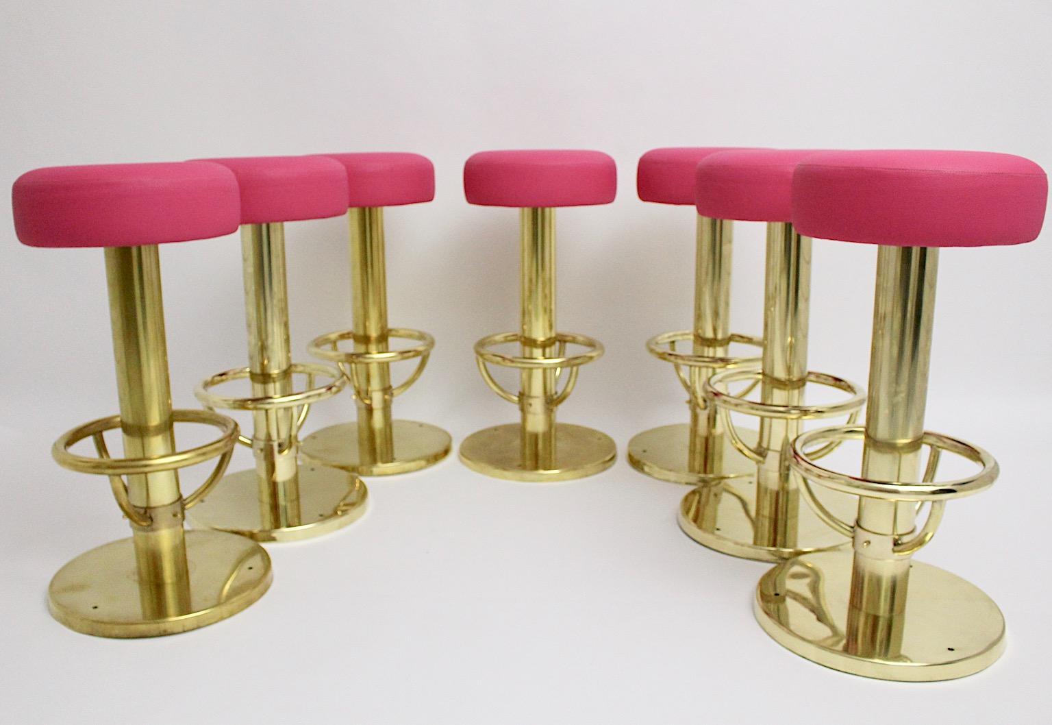 Mid-Century Modern vintage up to seven bar stools designed 1960s Austria from solid brass and faux leather in bold pink color tone.
The brass frame was polished some times ago and get character in the meantime by beautiful brass patina, which is