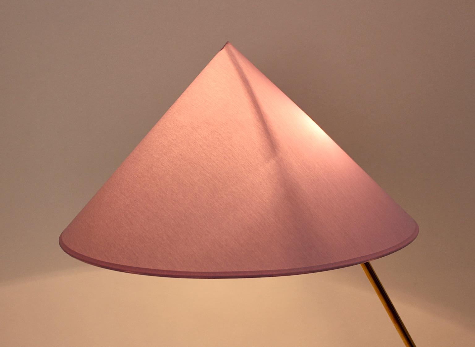 Mid-Century Modern vintage floor lamp model Golf Club by Rupert Nikoll
circa 1955 Austria from solid brass.
The amazing floor lamp shows a brass tube stem and a golf club like base
with a triangle element.
The new made lamp shade from chintz in