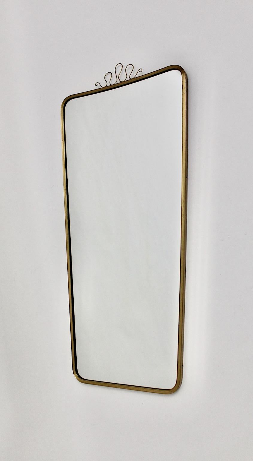 Mid Century Modern Vintage full length floor mirror or wall mirror from brass and mirror glass Italy 1950s.
A stunning new arrival, a full length floor mirror with a profile frame from brass with cute loops at the top.
At the backside the mirror
