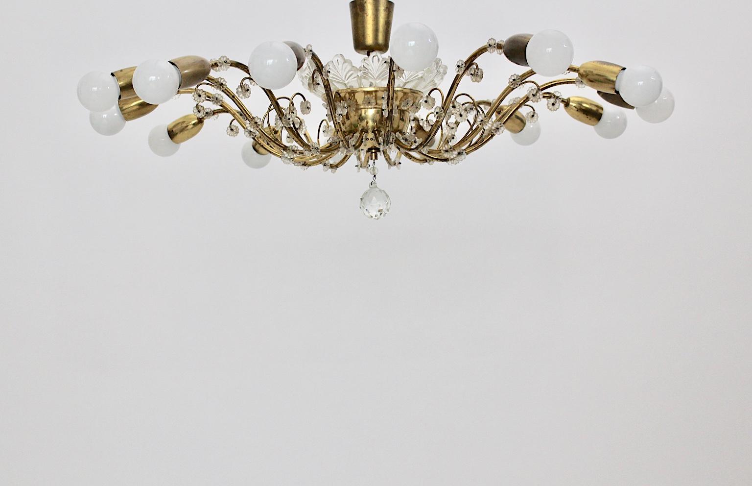A high-end Mid-Century Modern vintage brass and crystal glass chandelier or flush mount with 14 arms which was designed and executed by the popular firm J. & L. Lobmeyr in the heart of Europe, in Austria.
The vintage flushmount or chandelier was
