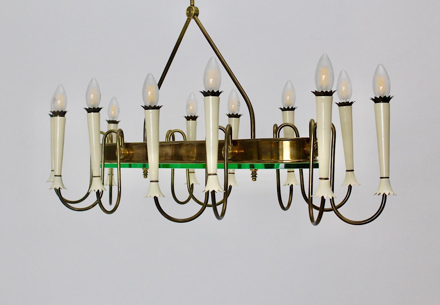 Mid-Century Modern vintage brass glass chandelier or pendant designed in the style of Pietro Chiesa in circa 1940 Italy for Fontana Arte.
This amazing and impressive and very rare chandelier was made out of brass and a greenish glass disc with 1 cm