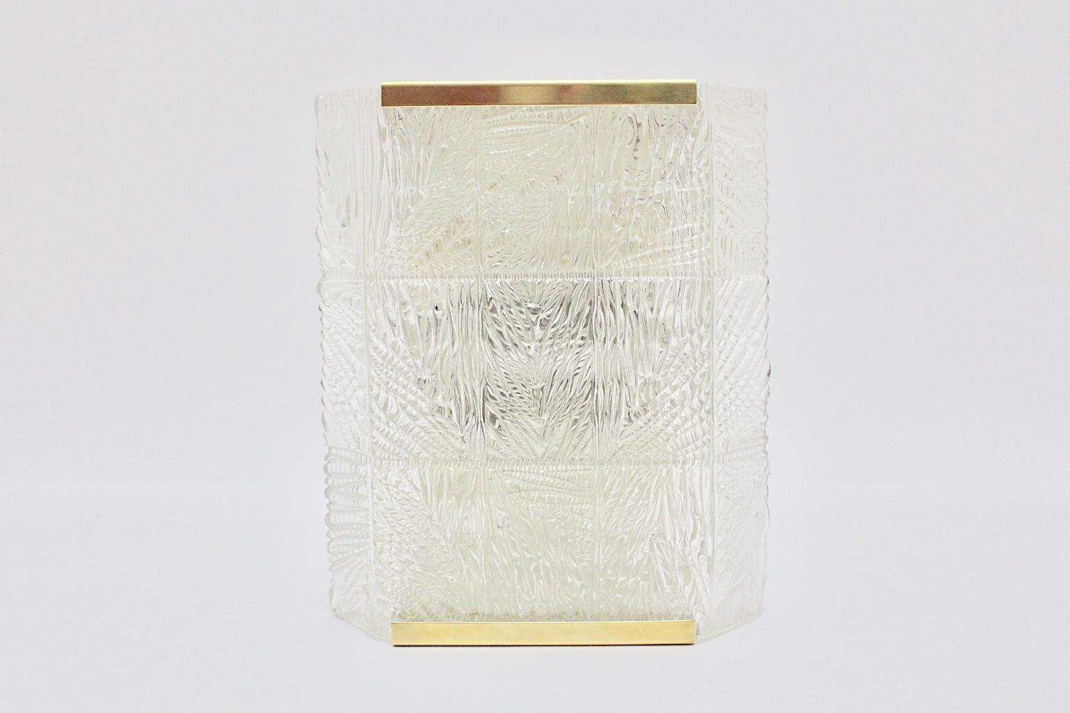  Mid-Century Modern vintage brass glass sconce or wall light, which was designed and manufactured by J. T. Kalmar 1960s, Vienna.
The wall-mounted sconce shows amazing and timeless design features.
With brass details and clear textured glass the