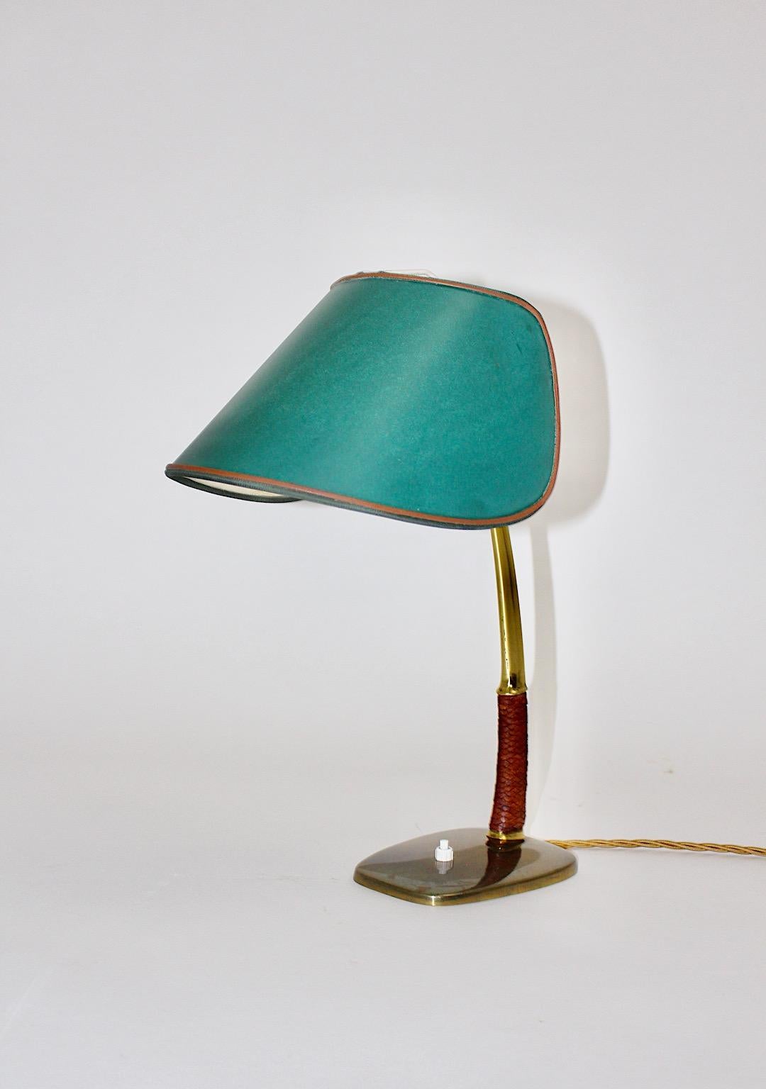 Mid-Century Modern vintage table lamp or desk lamp from brass, leather and nickel plated metal Mod. 1191 Arnold which was designed and manufactured by Kalmar in Vienna 1950s.
This rare table lamp shows a braided leather grip and and an adjustable