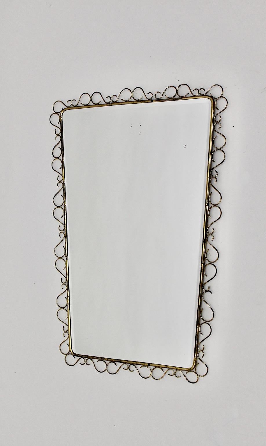Mid Century Modern vintage wall mirror or floor mirror from brass and mirror glass 1950s Italy.
A stunning wall mirror with delicate loops from brass with brass frame in rectangular conical shape.
The delicate loops run around the frame and provide