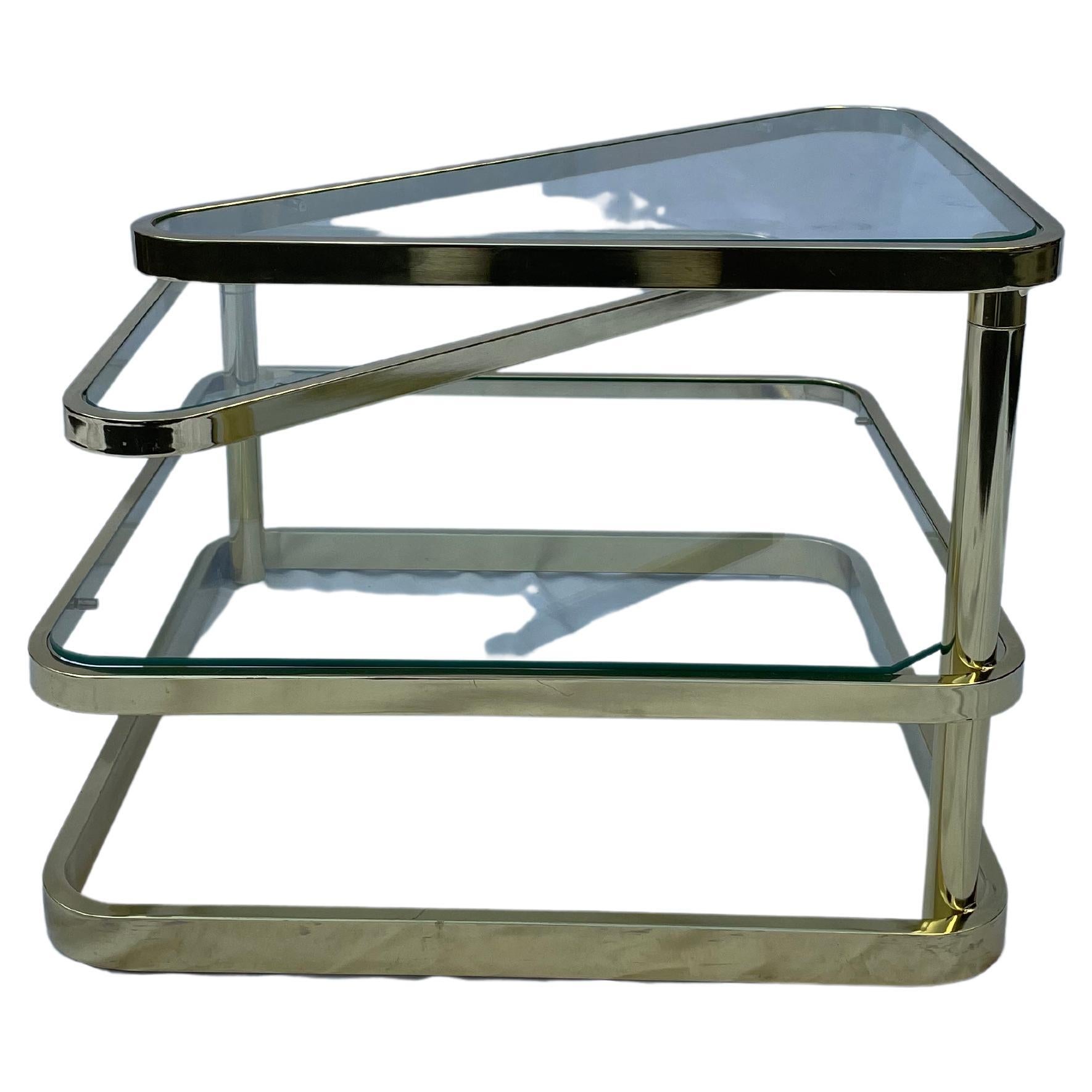 Mid-Century Modern brassed metal and glass coffee table shows two swiveling plates with the maximum width of 55