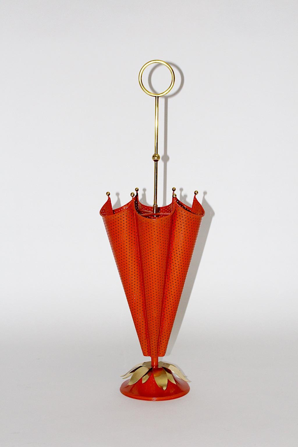 Mid-Century Modern vintage red umbrella stand from perforated metal in orange color tone with brass details attributed to Mathieu Matégot, France, 1950s.
An amazing and beautiful umbrella stand from perforated metal body with lovely brass