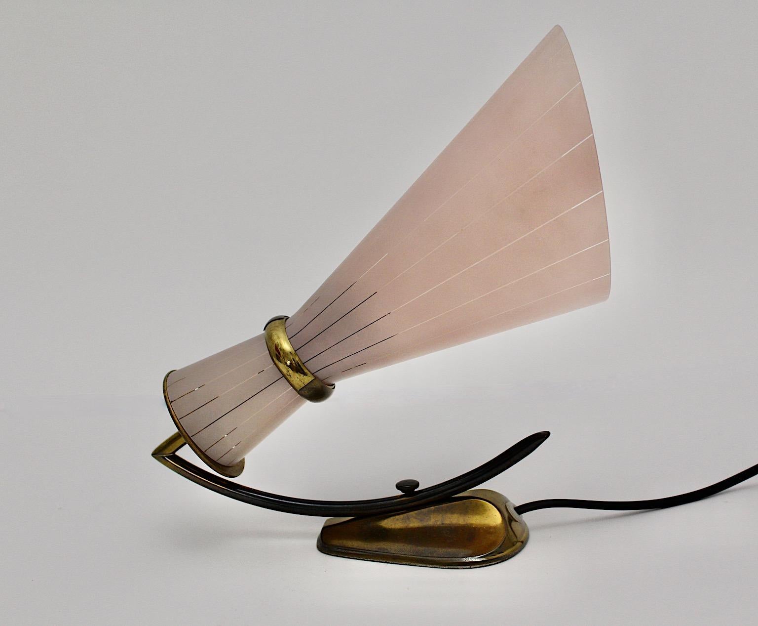 Mid-Century Modern Vintage sconce of table lamp by Stilnovo from brass and striped soft pink glass shade, 1950s Italy.
This stunning conical shaped sconce or wall lighting is as amazing as functional.
The graceful and delicate proportions feature