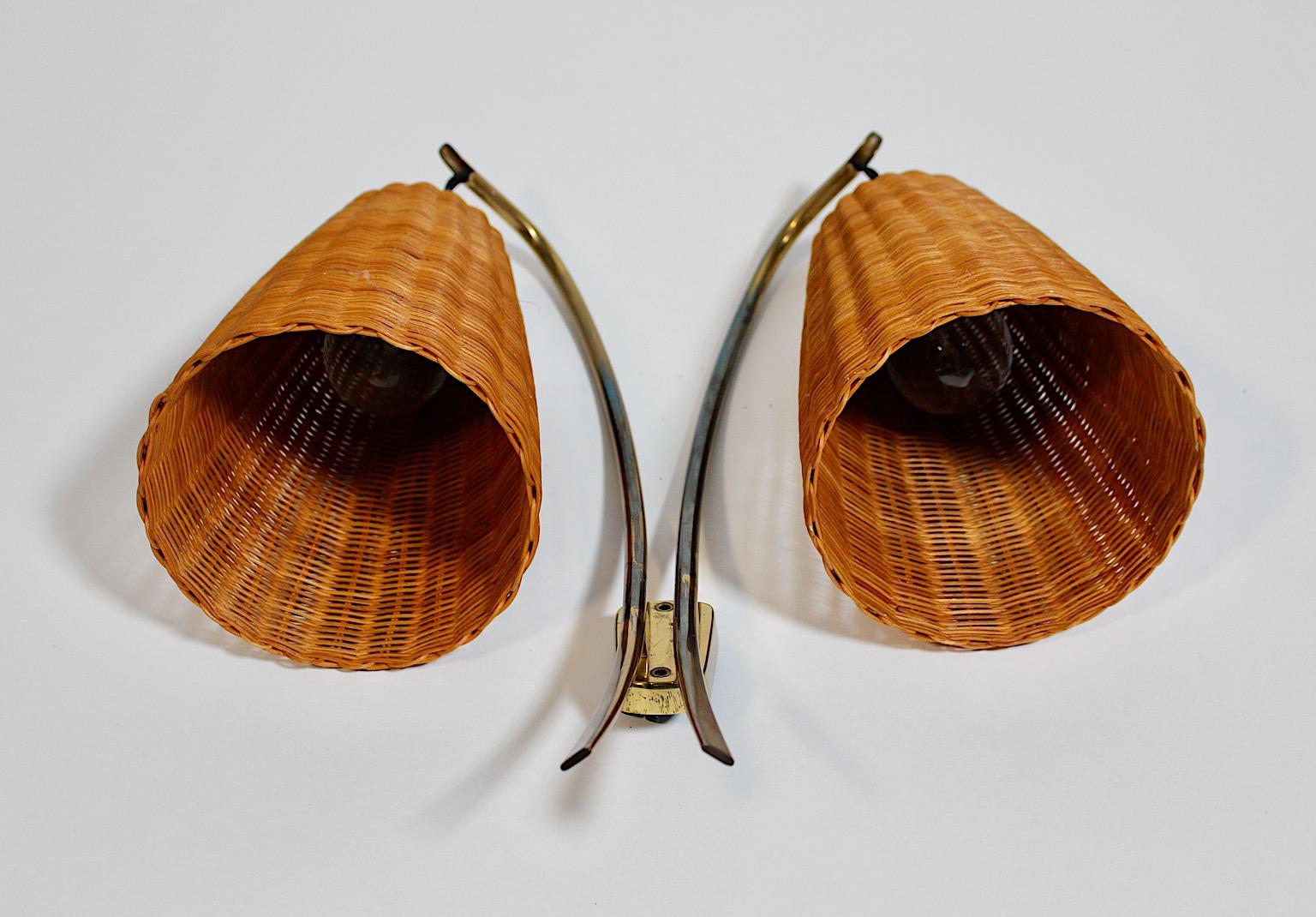 Mid-Century Modern vintage organic wall light or sconce by Kalmar from rattan and brass 1950s Vienna.
A stunning wall light by Kalmar from brass and rattan network.
This sconce shows two E 27 sockets and are rewired.
The sconce is in good