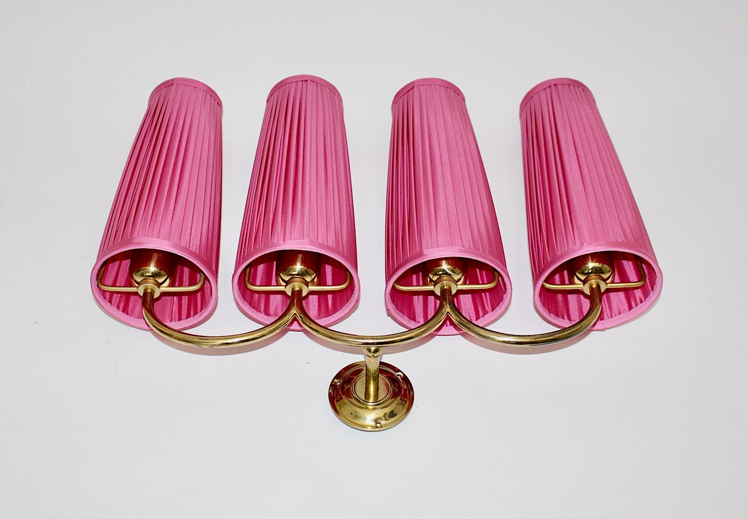 Mid-Century Modern vintage wall sconce from solid brass design attributed to Josef Frank
for Svenskt Tenn 1950s Sweden.
The slightly curved amazing wall sconce from solid brass shows four arms with E 27 sockets and
new lamp shades with pleats.