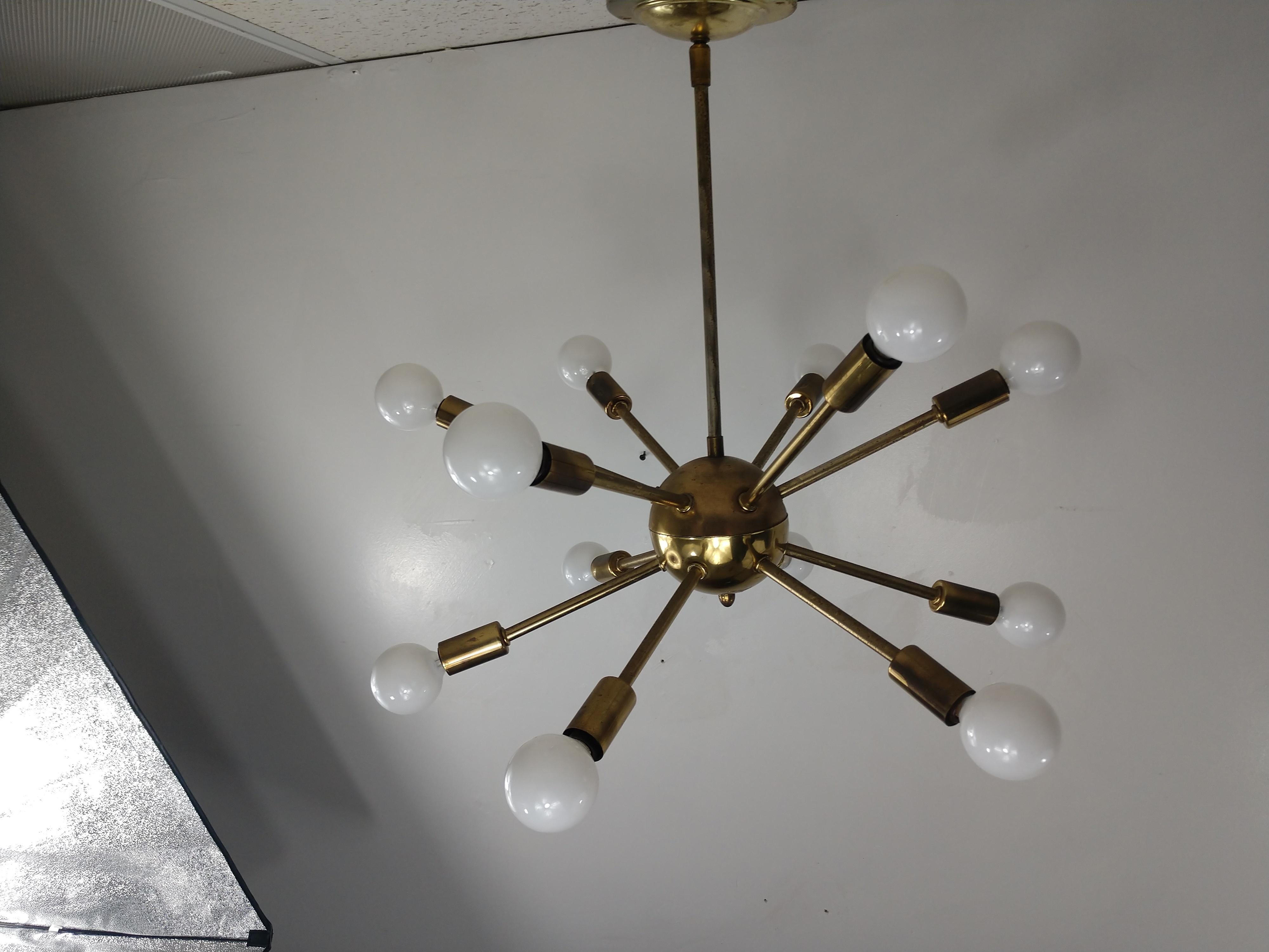 Original Sputnik chandelier from the mid-1950s with 12-light for illumination. All brass with some minor tarnish, age related. Wiring is crisp and sound, has the original adjustable ceiling canopy. This item can be parcel posted.