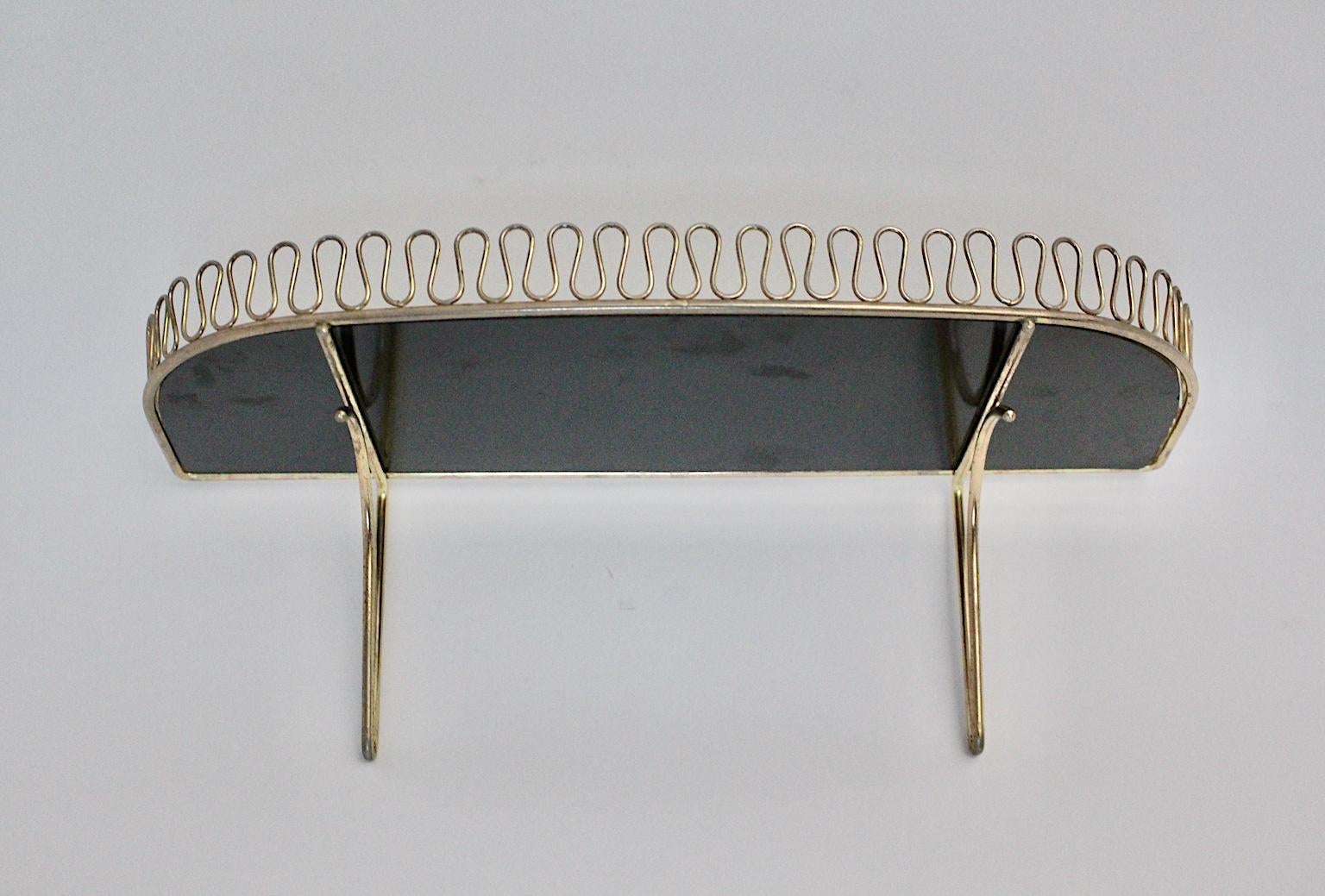 Mid-Century Modern vintage brass wall shelf, which was designed by Josef Frank for Svenskt Tenn, 1950s, Sweden.
Small metal loops decorates the delicate wall shelf. Furthermore it has a tray, which was made out of black and white Formica.
Great, so