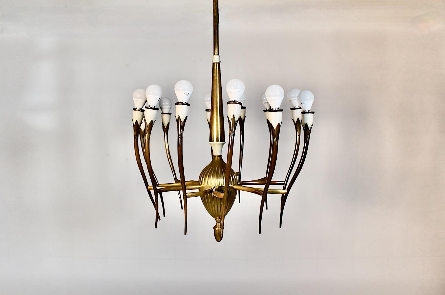 Mid Century Modern vintage chandelier from brass and white metal with twelve ( 12 )  arms, attributed ( after ) Gio Ponti Italy, 1950s.
An amazing chandelier from brass and white lacquered metal with 
twelve ( 12 ) arms flower like and E 14