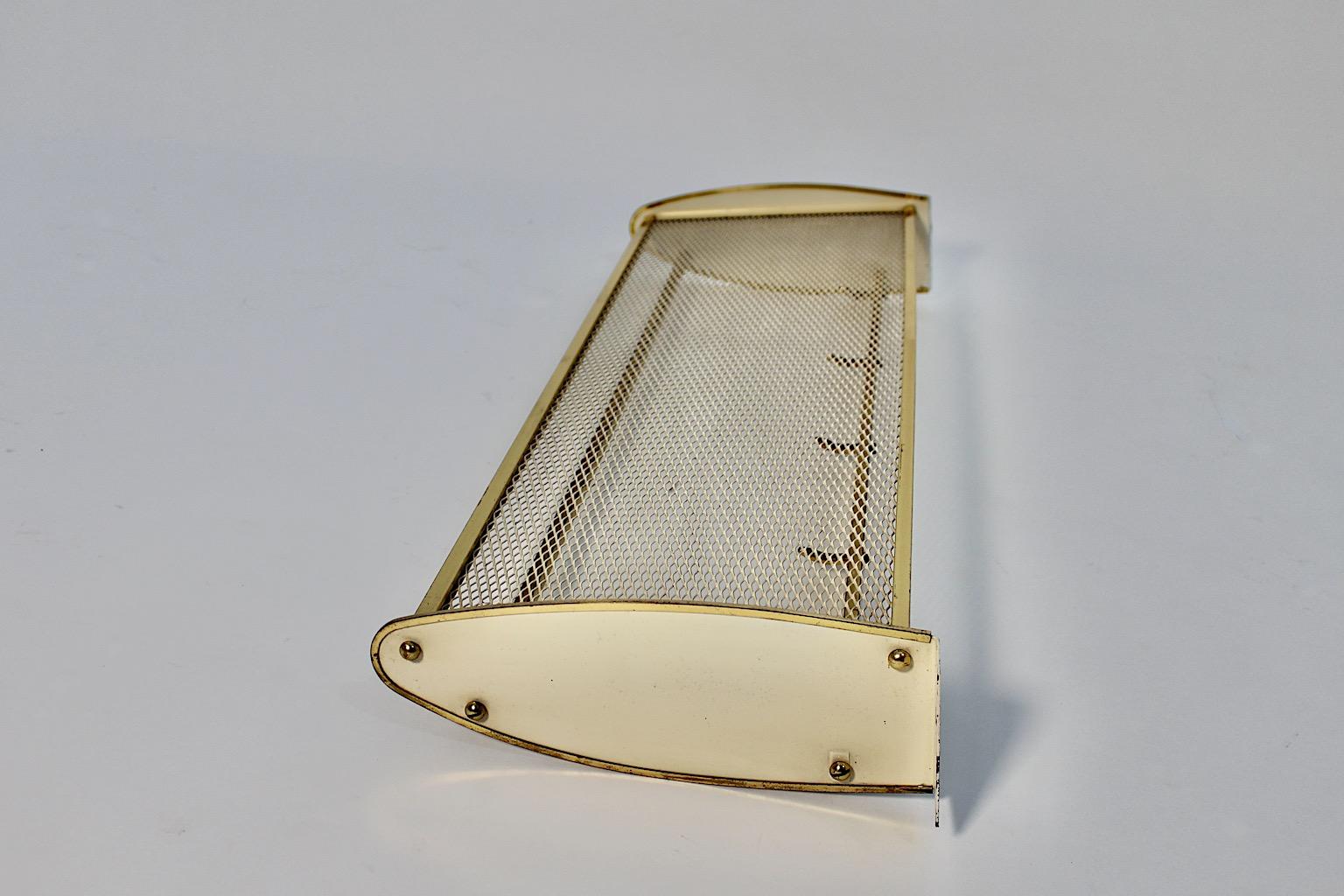 Mid Century Modern vintage coat rack or hat rack from brass and white metal 1950s Italy.
A wonderful and elegant wall mounted coat rack or hat rack from white lacquered perforated metal and brass details Italy, 1950s.
This stunning wall mounted coat