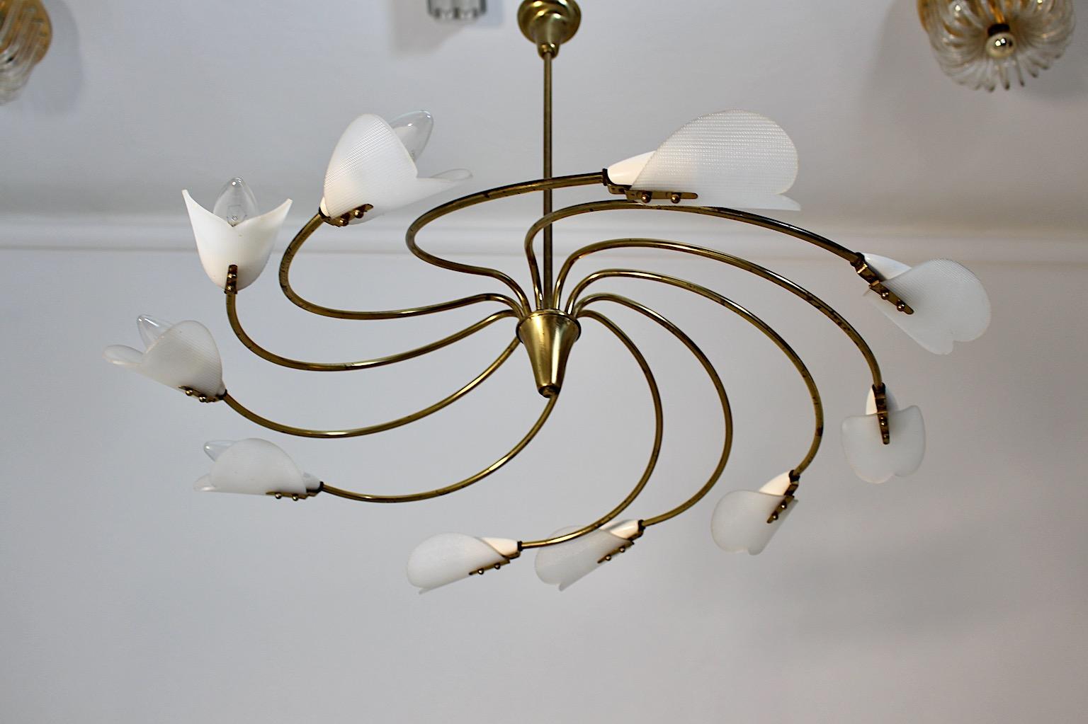 Mid Century Modern vintage chandelier model Tornado by Rupert Nikoll from brass and white plastic, 1950s Vienna.
An amazing circular chandelier with ten ( 10 ) arms and white plastic shades in cone shape showing wonderful movement like a small