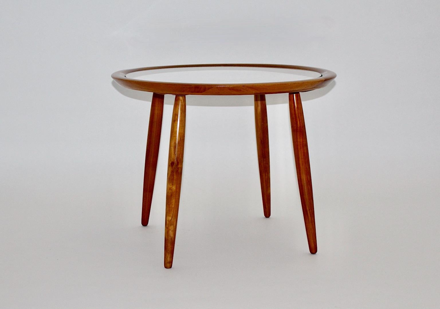 Mid-Century Modern vintage coffee table or side table from cherry wood by
Max Kment Austria 1949/1950 for Kunstgewerblichen Werkstätten Max Kment.
The coffee table from solid cherry wood in a warm color tone is shellac polished, while the coffee