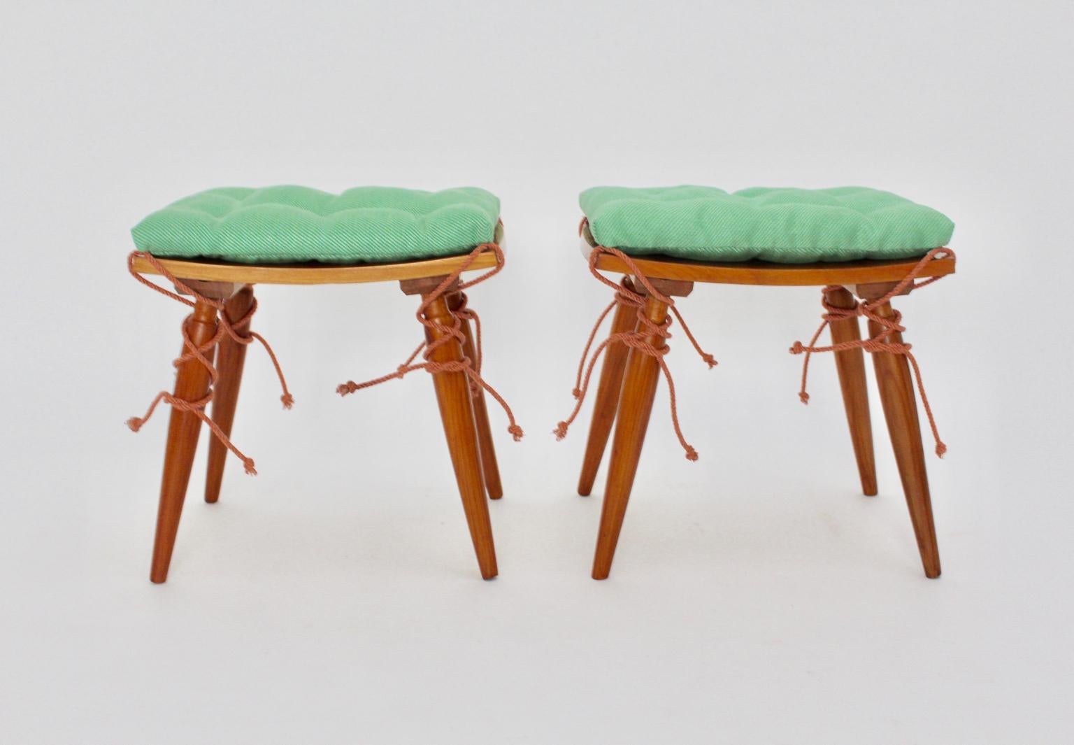 This pair of cherrywood stools were designed and made in Vienna, circa 1950. Also the set of two stools features a curved seat and conical shaped legs.
Furthermore the stools are carefully cleaned and shellac hand polished. Renewed cushions which