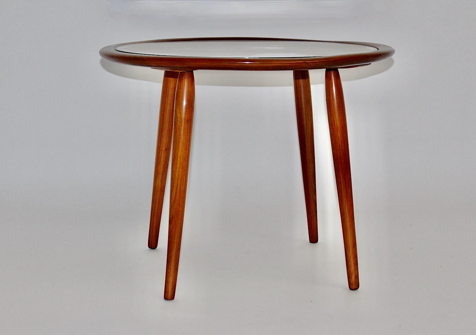 Mid-Century Modern vintage circular like coffee table or side table by Max Kment for Kunstgewerbliche Werkstätten Max Kment 1949/50, Austria.
Solid shellac polished by hand cherry wood frame in stunning warmth color tone, strutting from beech and