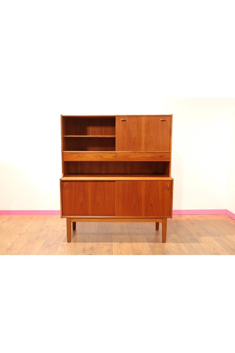 This is a rare and super stylish vintage mid century sideboard by the renowned maker, McIntosh, one of the finest furniture makers of this period. The design of this stunning retro sideboard is very heavily influenced by the Danish furniture