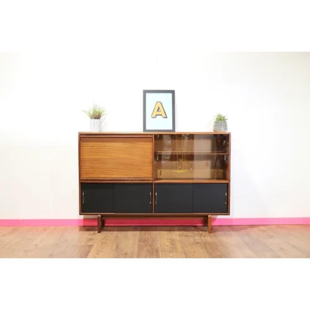 Introducing the Mid Century Modern Vintage Display China Cabinet by Beaver and Tapley, a stunning and versatile piece of furniture for any mid century modern enthusiast. This cabinet features ample storage space for all of your dining and kitchen