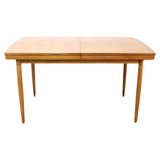 A stunning  mid century dining table by Morris of Glasgow.  This gorgeous versatile table has an inbuilt leaf that folds out and would easily sit 6 people.

  The table has a beautiful grain throughout a real head turner.