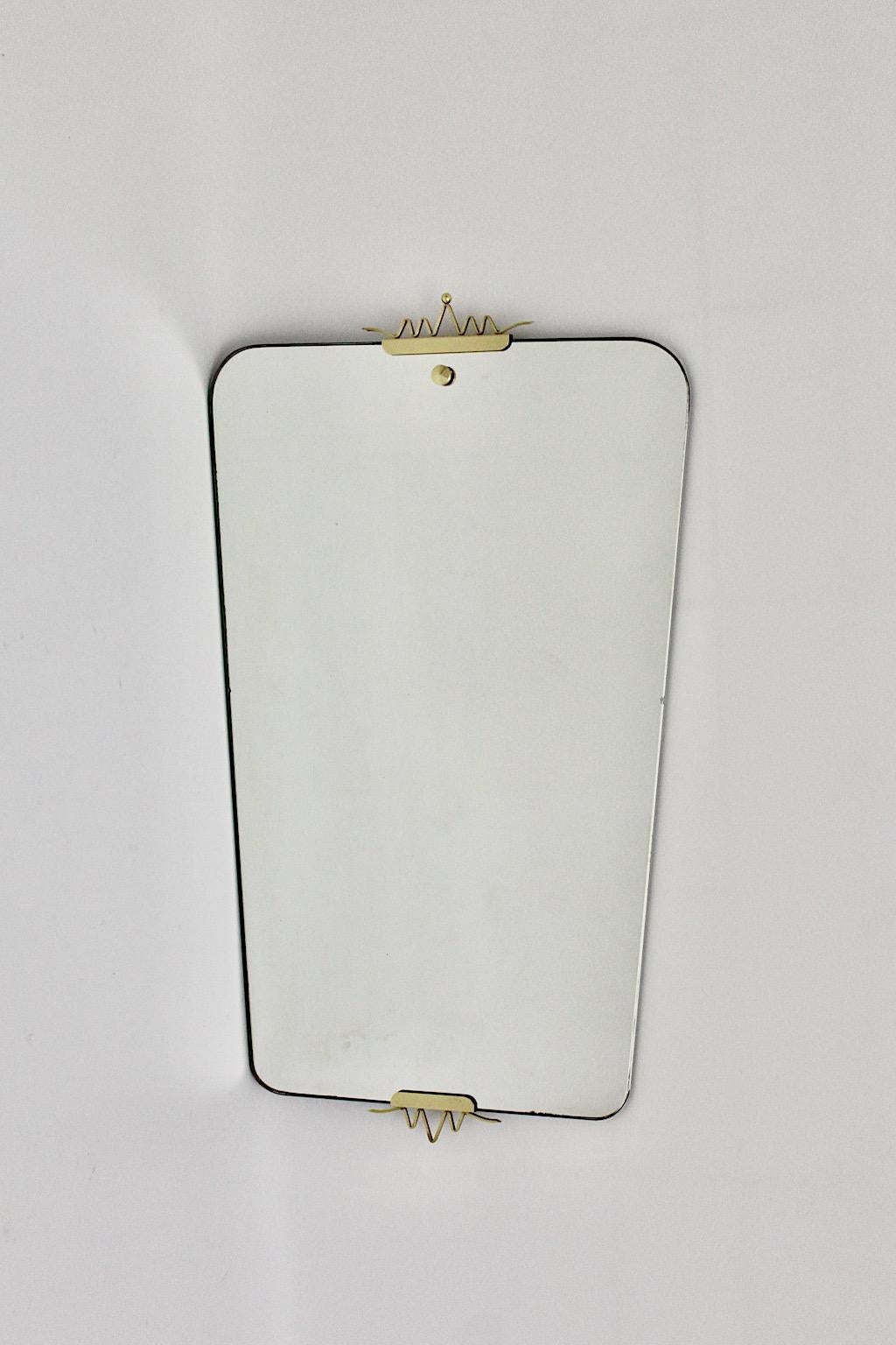 Mid-Century Modern vintage full length mirror wall mirror from mirror and brass Gio Ponti style 1950s Italy.
An amazing wall mirror with playful crown like decor from brass while the mirror shows rectangular shape with slightly rounded