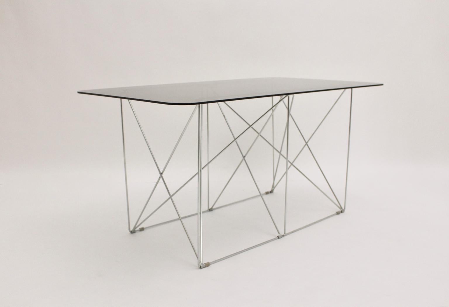 This fantastic foldable metal construction with a loose smoked glass plate ( thickness 0.8 cm ) was designed by Max Sauze, circa 1970, France. It is great to use as a dining table or as a writing table.
The vintage condition is very good.
Approx.