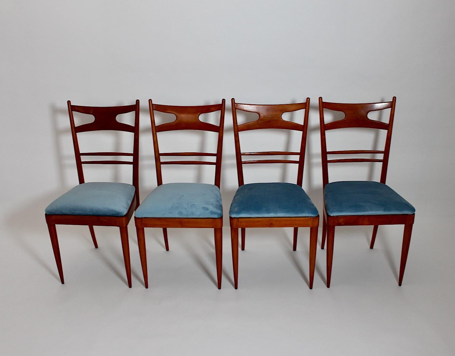 Mid-Century Modern vintage four (4) dining room chairs from cherry wood and seats covered with pastel blue velvet designed and manufactured 1950s Italy.
A wonderful set of four dining room chairs from cherry wood and blue velvet seats, while the