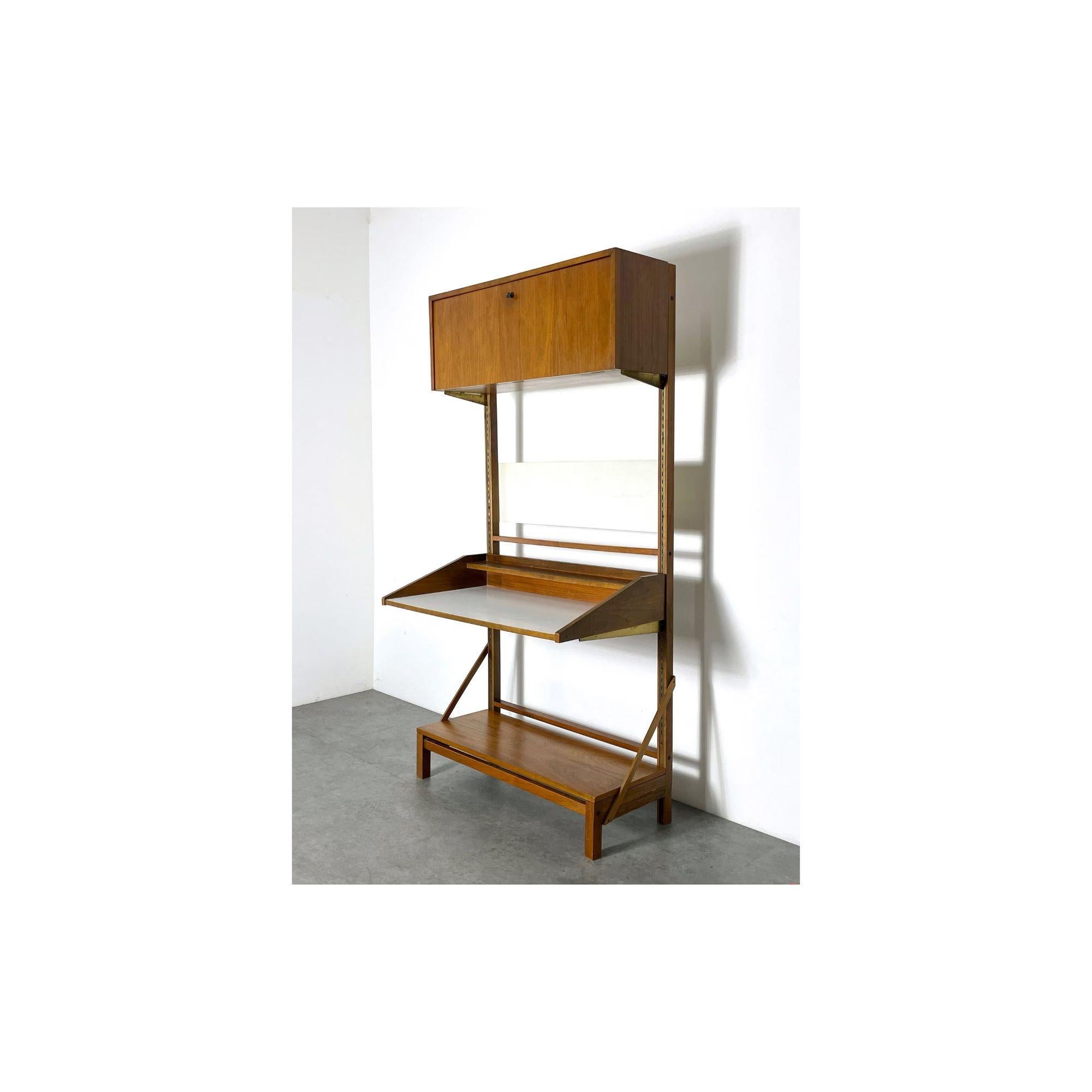 Vintage Mid Century Modern Freestanding Wall Unit Desk 

Great modernist secretary wall unit circa 1960s
Freestanding with adjustable upper drop front cabinet and floating desk
Walnut construction with white laminate surface and black hourglass