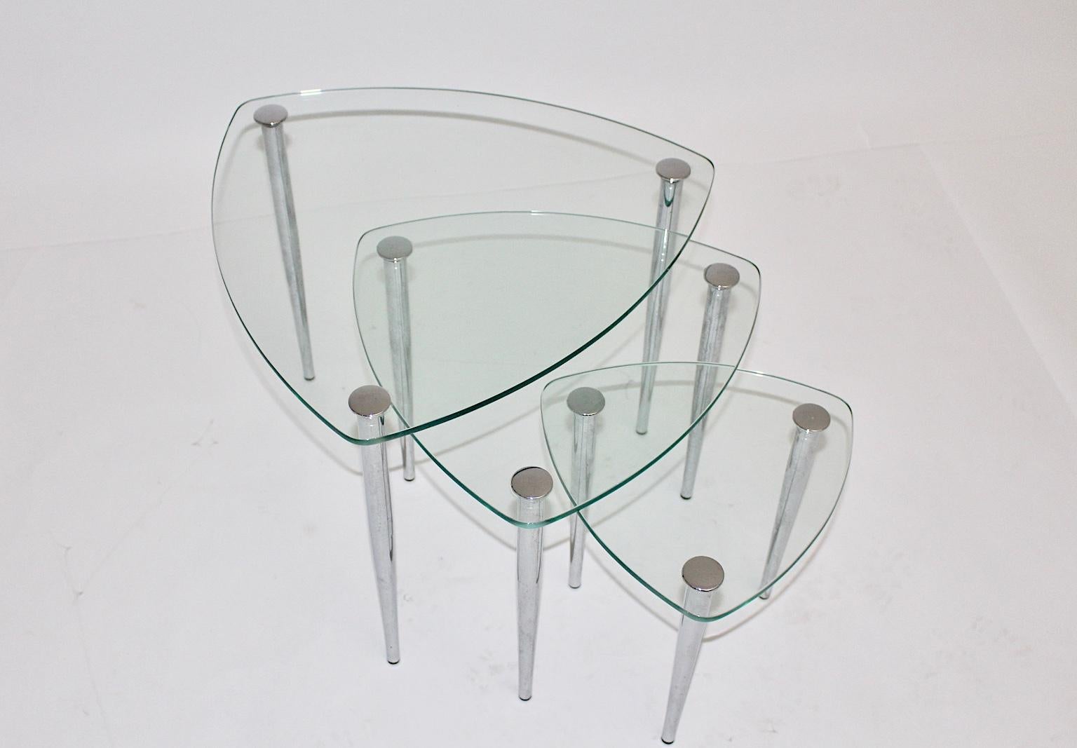 This set of 3 clear glass nesting tables / sofa tables in triangle form shows also chromed metal feet with rubber sabots.
The sizes from the nesting tables are various.
The smallest table has the measures: Diameter 28 cm and Height 28 cm.
The