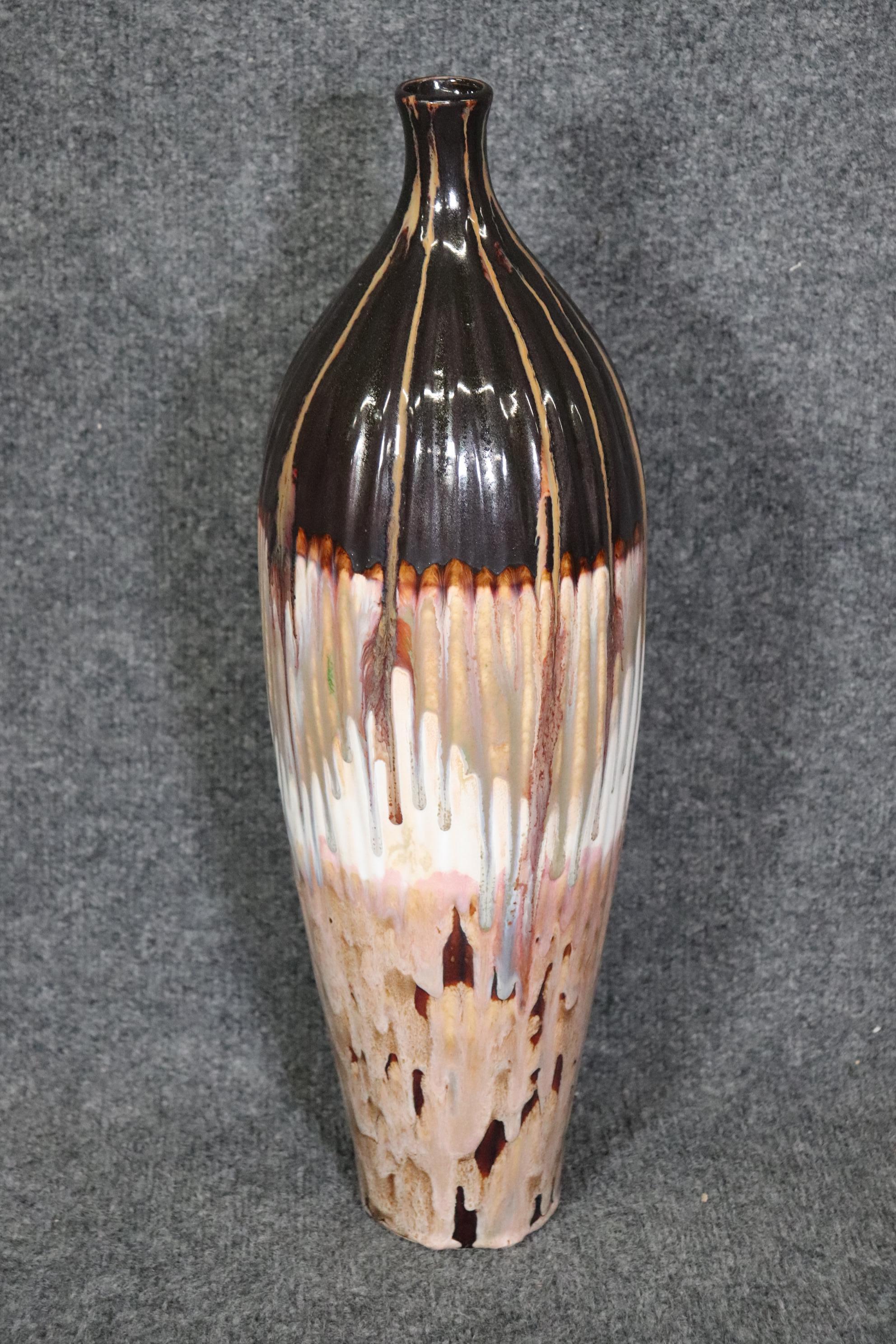 Dimensions: Height: 20 in Width: 6 1/4 in Depth: 6 1/4 in 

This Vintage Mid Century Modern pottery art vase is made of the highest quality. If you look at the photos provided, you will see the flowing design in mid century colors. This vase will