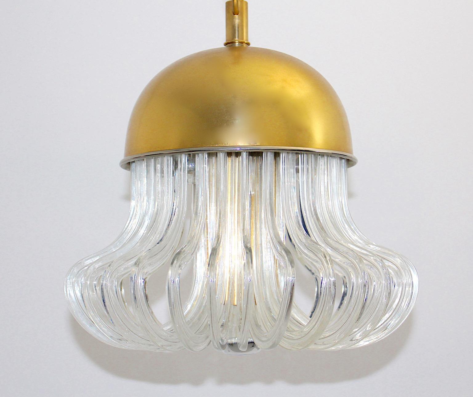 Mid Century Modern vintage crystal glass and gold plated brass chandelier by Cari Zalloni for Bakalowits 1960s Vienna.
An outstanding chandelier from gold plated brass and crystal glass features a brass dome and thirty pieces of curved clear crystal