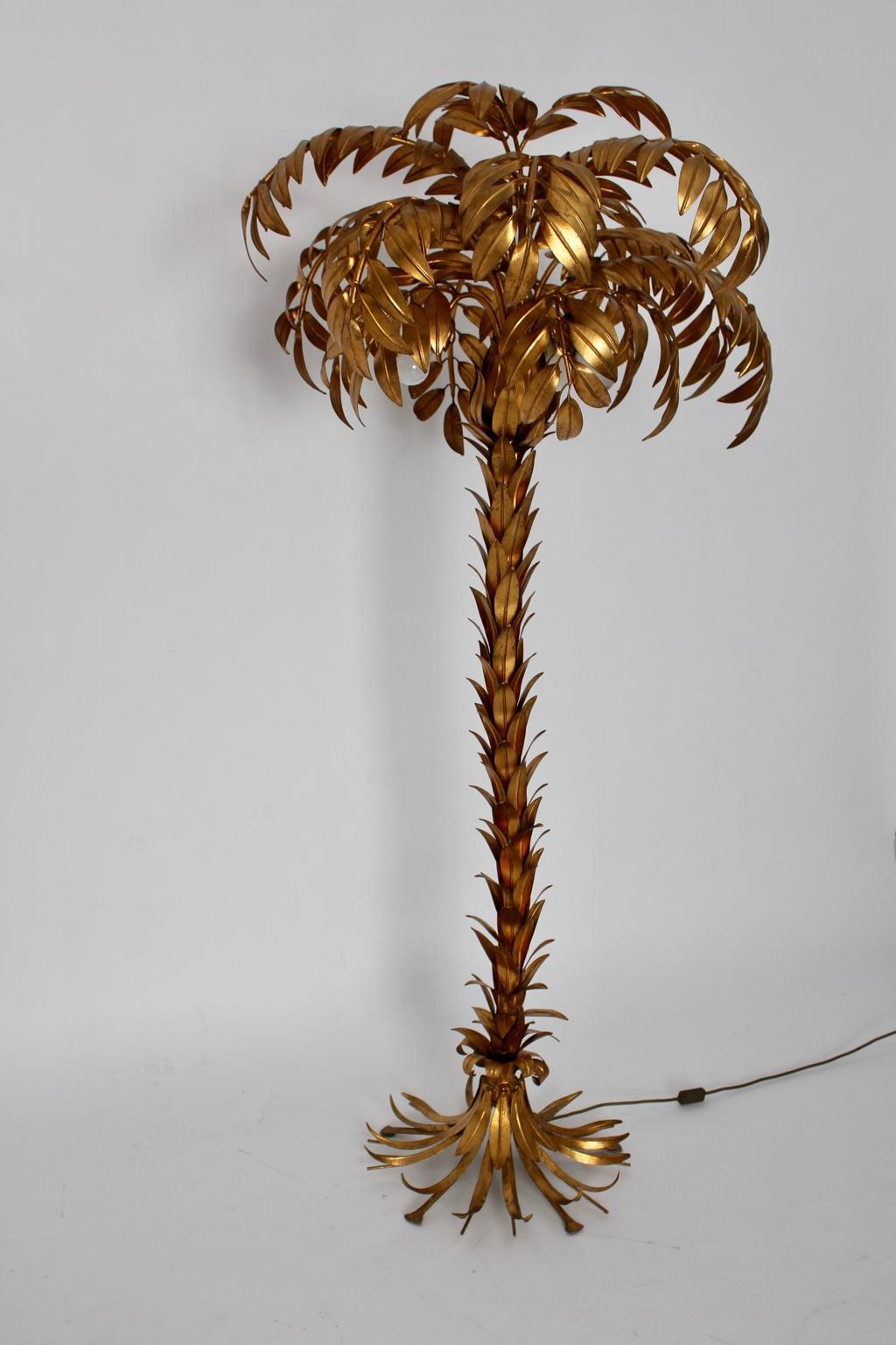 Hollywood regency style vintage golden palm tree floor lamp by Hans Kögl, Germany shows very good vintage condition.
Three E 27 sockets are hidden in the tree crown and the bulbs create a wonderful warm light shine.
Also it features an on/off