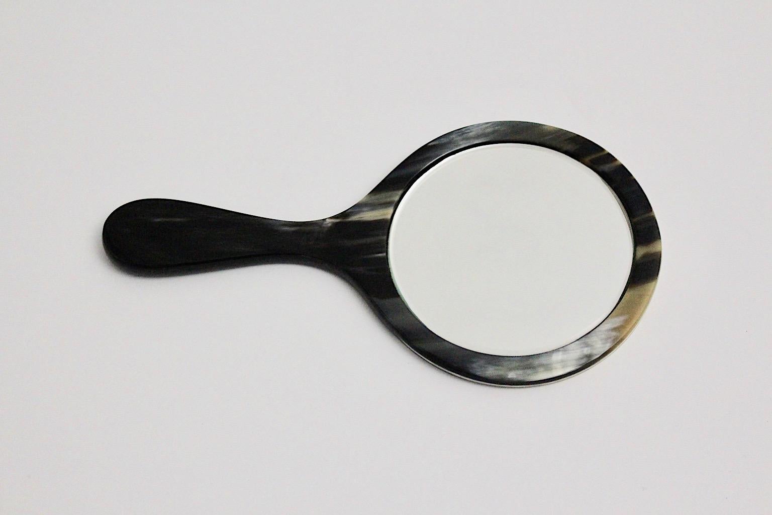 A Mid-Century Modern vintage hand mirror, which was designed and manufactured in 1950s, Austria.
The mirror stands out due to the beautiful pattern of the material.
The hand mirror is in very good condition for both, while the mirror glass shows