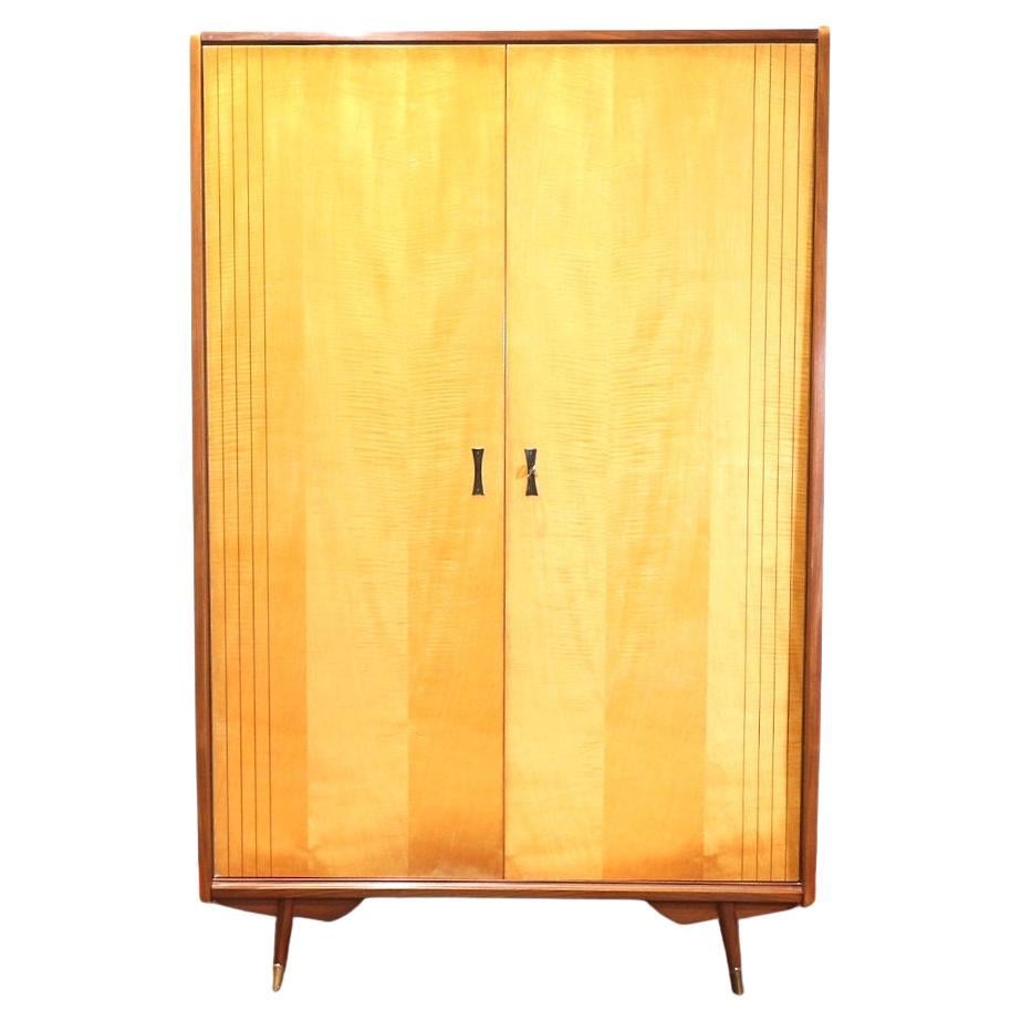 Discover the exquisite charm of mid century modern design with this stunning vintage armoire by renowned Italian cabinet maker Marino. Crafted from warm, honey-toned maple, it embodies the sleek lines and functional elegance of Danish style. At Mid