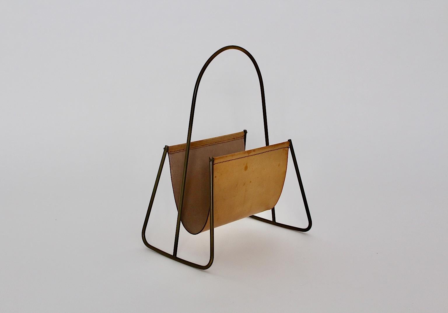 Mid-Century Modern vintage leather brass magazine rack, which was designed by Carl Auböck, 1950s.
The magazine rack consists of a brass frame and a light high quality leather bag for magazines.
The brass frame of the magazine rack shows beautiful