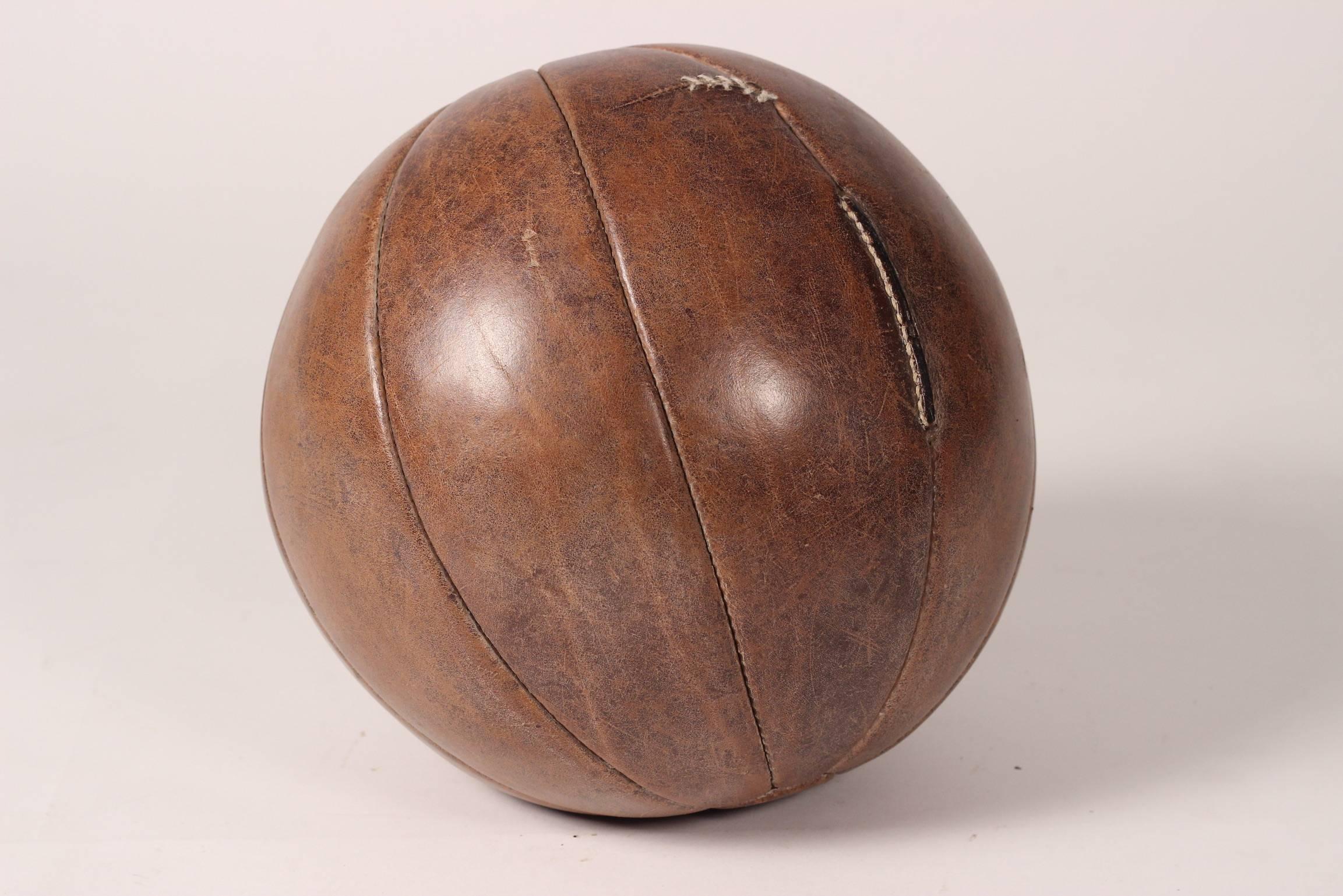 Vintage leather medicine ball, with minor stitched repair, which in our opinion adds to the character of the piece. This ball is structurally sound, with wonderful patina that only comes from genuine age and wear.