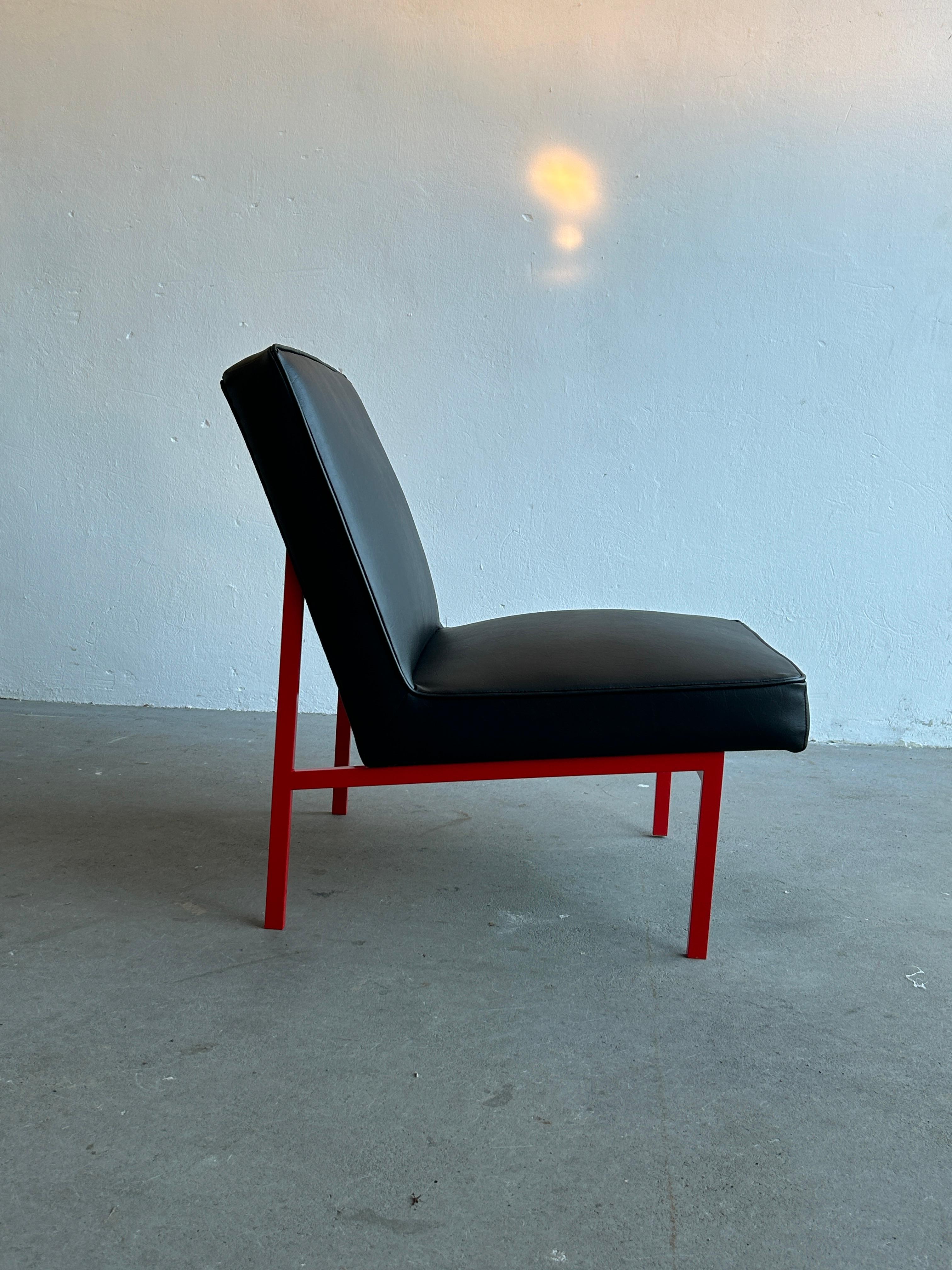 A beautiful vintage Mid-Century-Modern black faux leather and red frame lounge chair. Designed by Niko Kralj and produced by Stol Kamnik, Yugoslavia, during the 1970s. 

Completely restored, repainted in the original red and metal coloring, and
