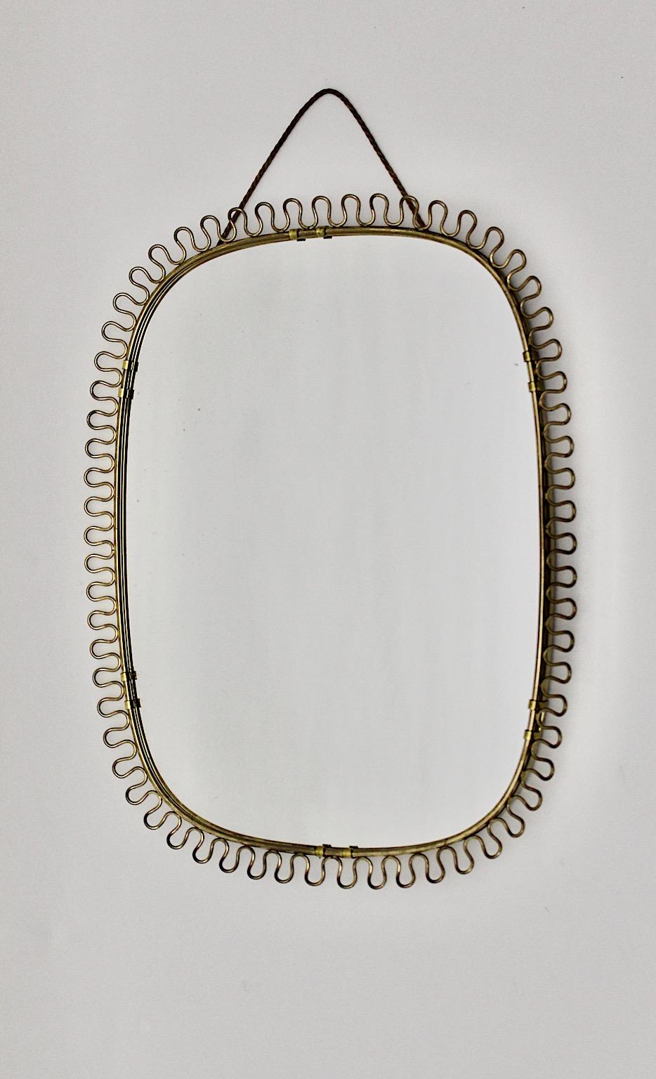 Mid-Century Modern vintage wall sunburst mirror oval like by Josef Frank
for Svenskt Tenn 1950s Sweden.
A stunning wall mirror with curved nice loops frame worked in brass in rare oval shape.
This sunburst mirror features elegant texture of