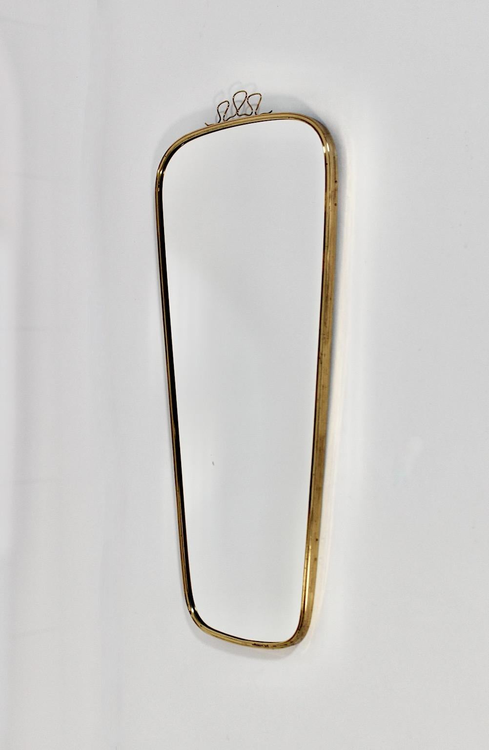 Mid-Century Modern vintage oval brass wall mirror with loops 1950s Austria.
An amazing wall mirror oval like with brassed frame and mirror glass in oval like form and cute loops at the top.
This wall mirror shows a wonderful size wether it would be