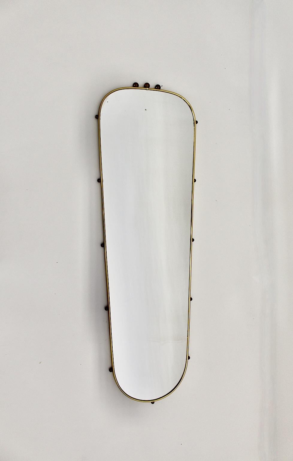 Mid Century Modern vintage oval form wall mirror or full length mirror from brass and mirror glass Italy 1960s.
Stunning vintage wall mirror with brass and spruce frame and ball like decor around the frame.
Good condition with minor signs of age
